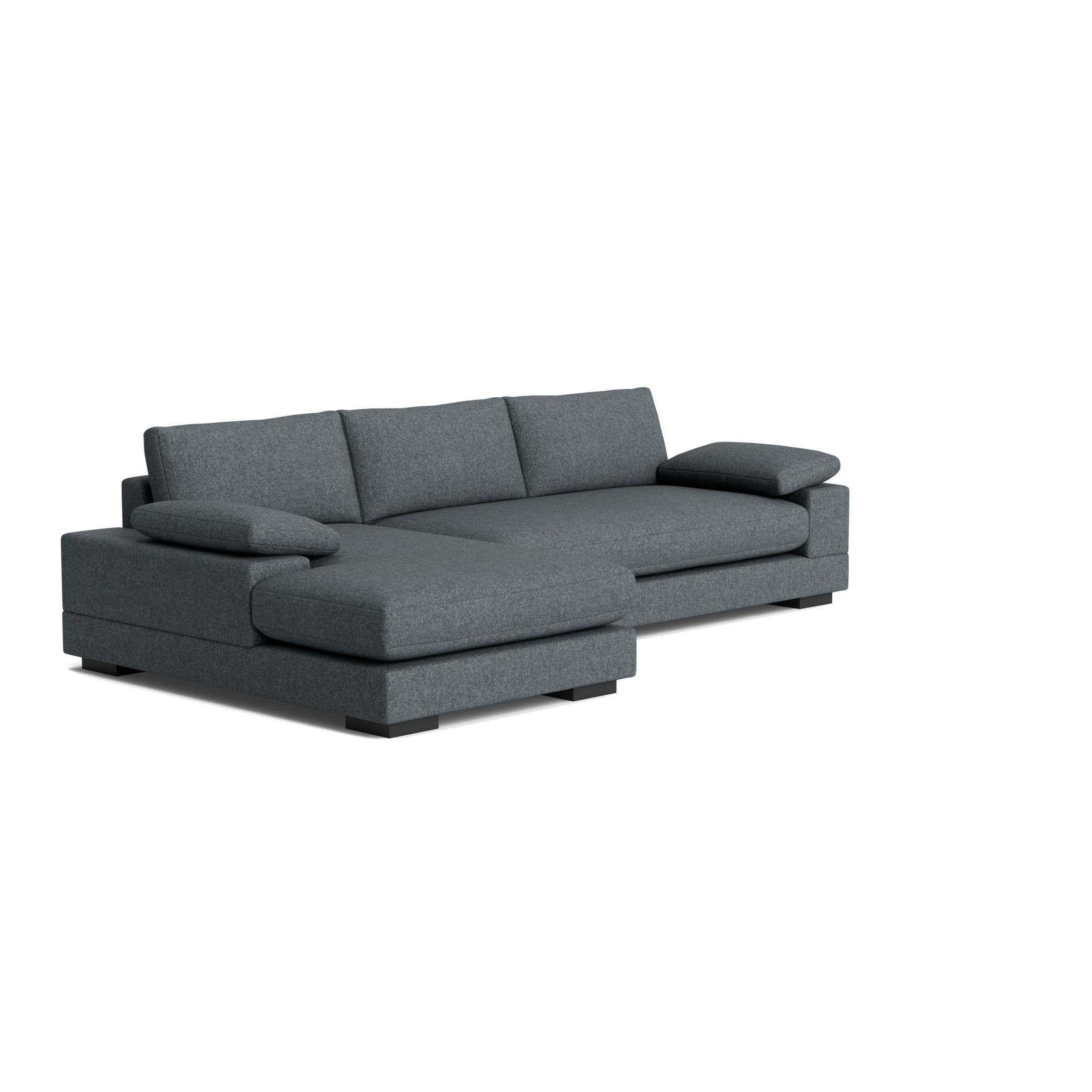 The Geometric Modern Sofa exudes understated elegance. Its extra-wide, rectilinear arms are adorned with relaxed throw pillows, all resting on a single, seamless bench seat—chic and effortlessly comfortable.