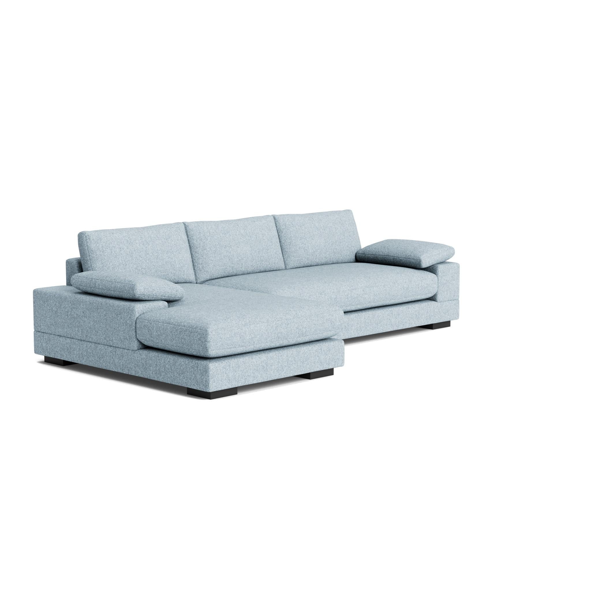The Geometric Modern Sofa exudes understated elegance. Its extra-wide, rectilinear arms are adorned with relaxed throw pillows, all resting on a single, seamless bench seat—chic and effortlessly comfortable.