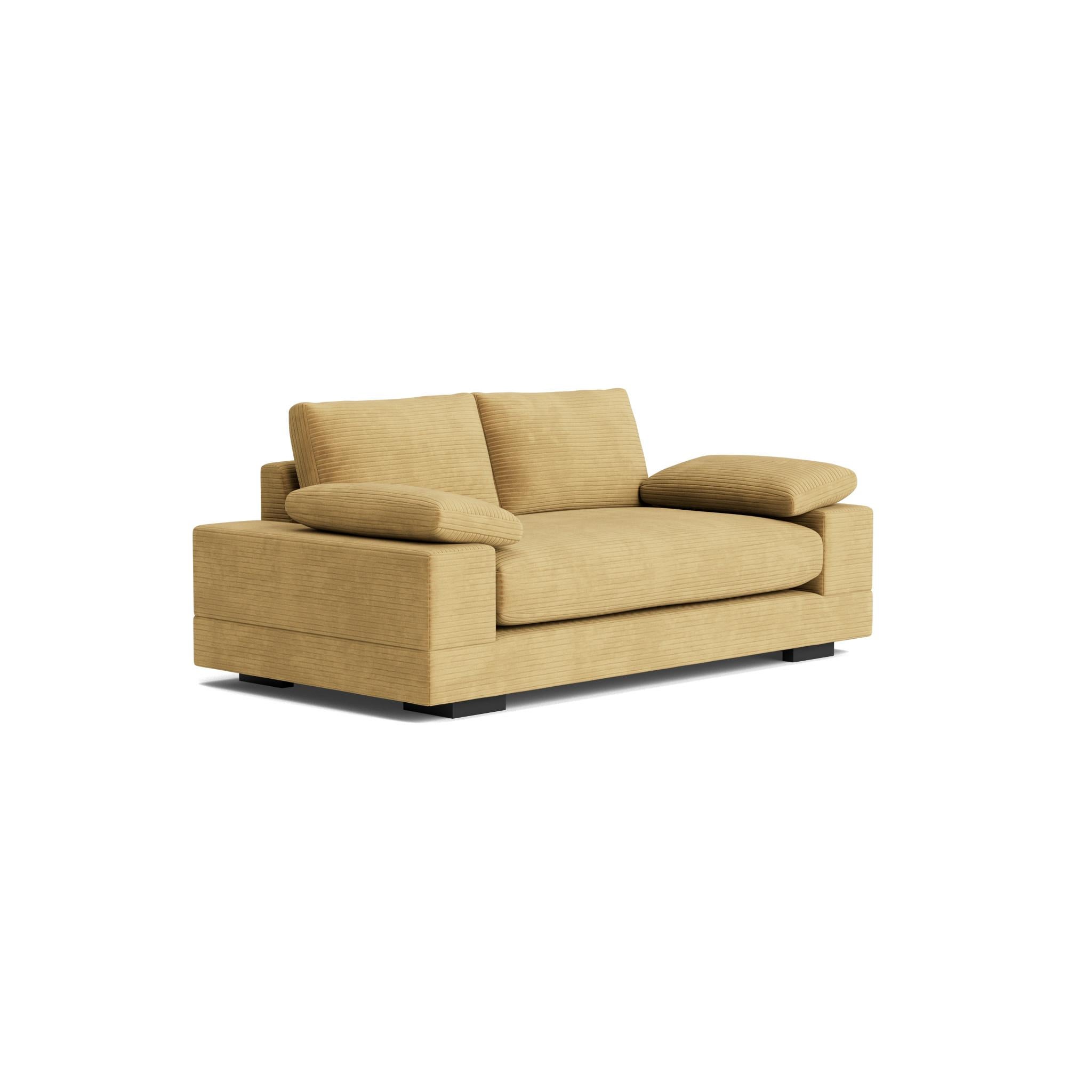 This sofa boasts a generously proportioned arm, its square profile offers a clean, contemporary aesthetic. Atop this sturdy base rests a plush, loose cushion arm rest. Relaxed, deep bench seating with plush premium cushions and webbed suspension
