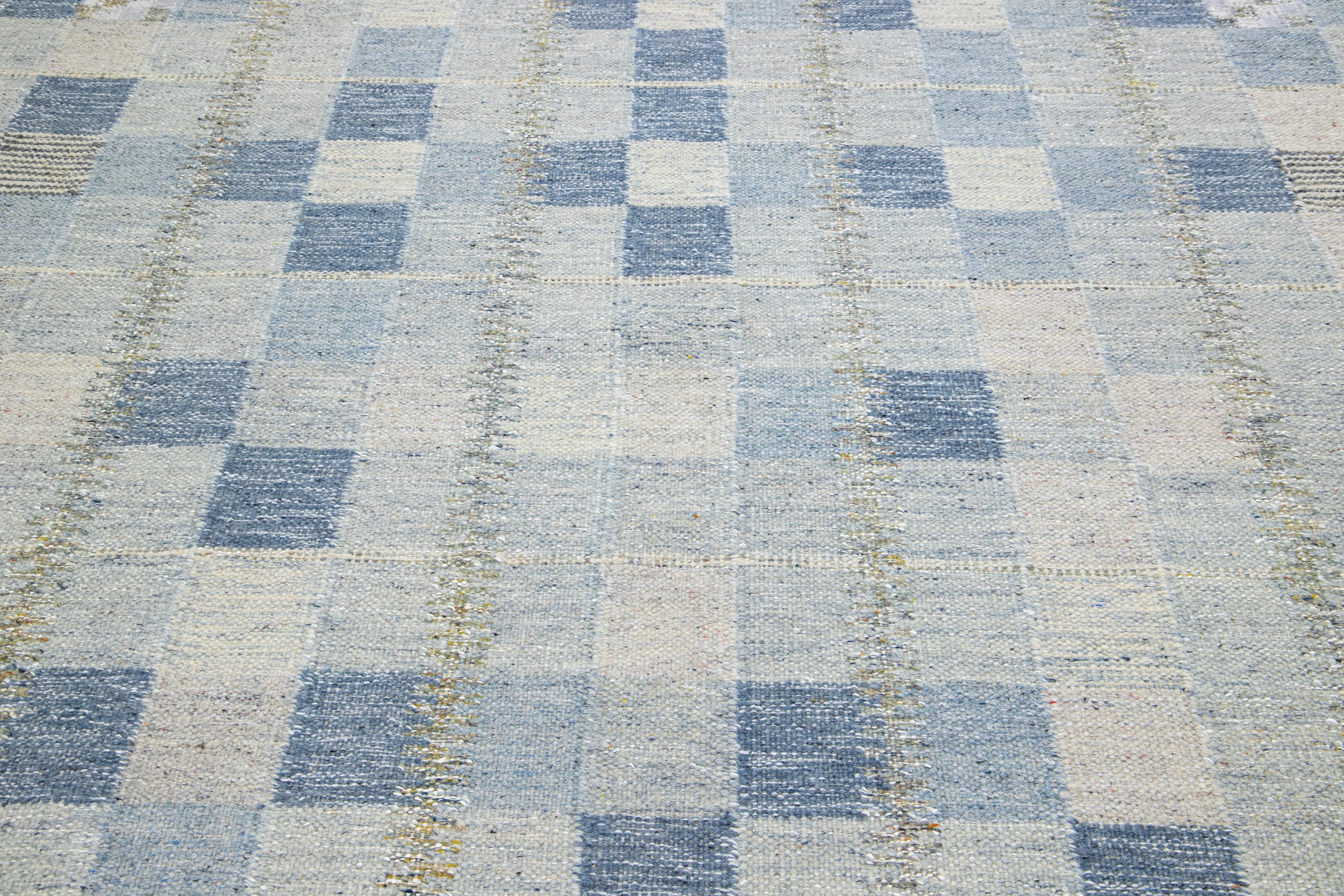 This flatweave rug features a chic contemporary Swedish design, highlighted by its subtle grey foundational color. It garners attention by including an intricate geometric pattern throughout the rug design. Additionally, it elegantly incorporates