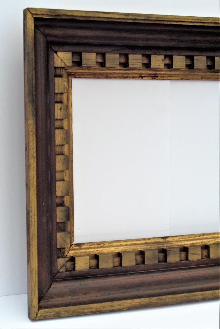 A  modernist brutalist style frame in dark stained oak wood and gold painted gilded deeply carved geometric block construction. American, circa 1930-1940 Great looking. Size of opening is approximately 15 1/2