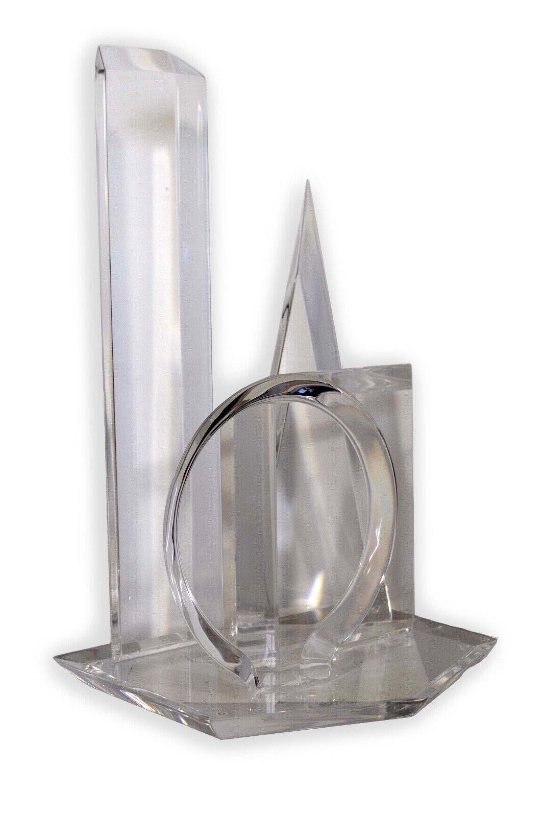 Van Teal's Geometric Multi Shapes Lucite Acrylic Sculpture is a captivating masterpiece that seamlessly blends artistic vision with geometric precision. Crafted from transparent lucite acrylic, this sculptural wonder features a mesmerizing array of