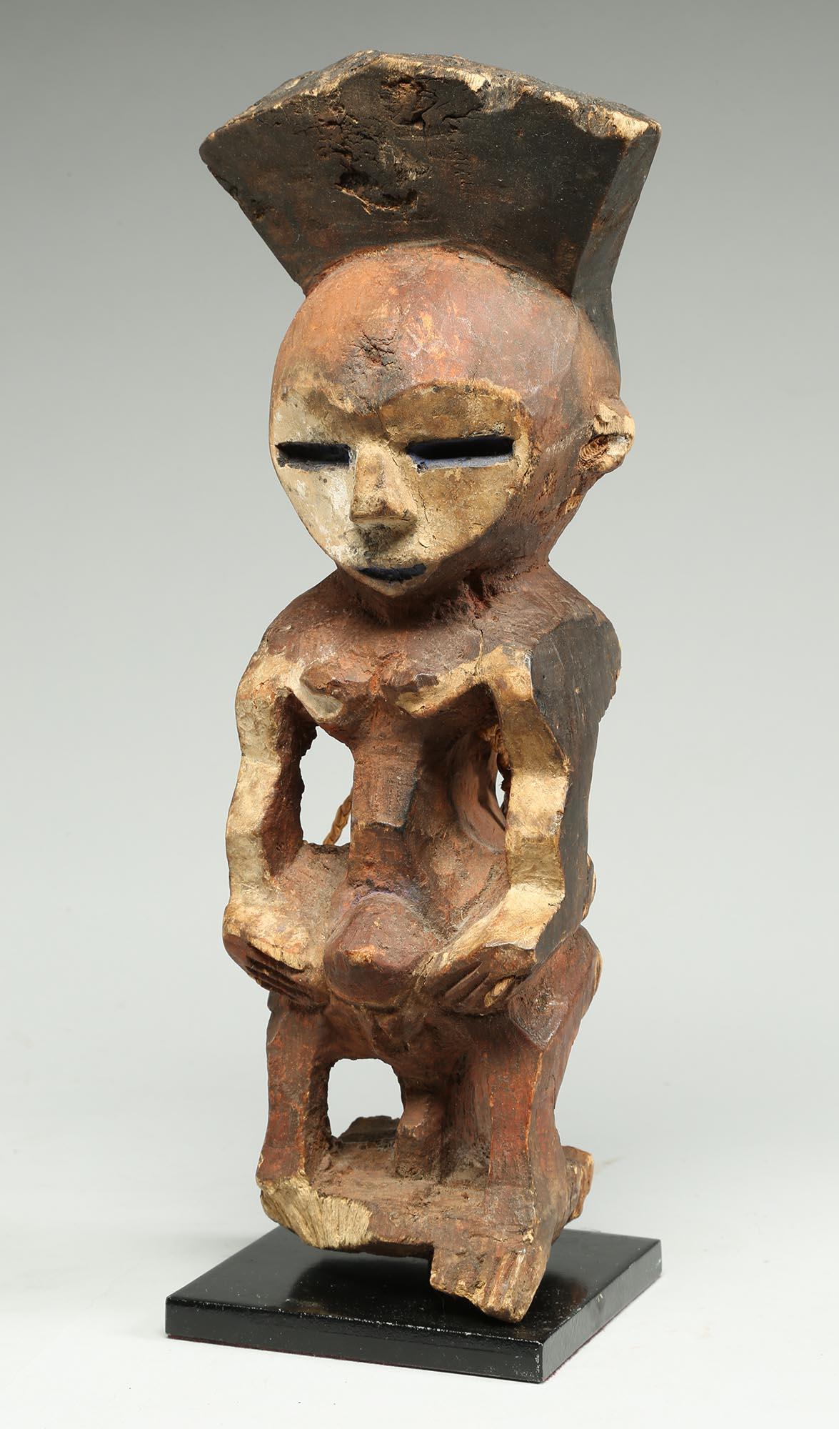 Geometric painted red, white and black standing Mbole figure, Democratic Republic of Congo, Africa.  Early 20th century Cubist Form with great zig zag profile. Ex - old private collection, California. On custom base, 11 1/2 inches high.