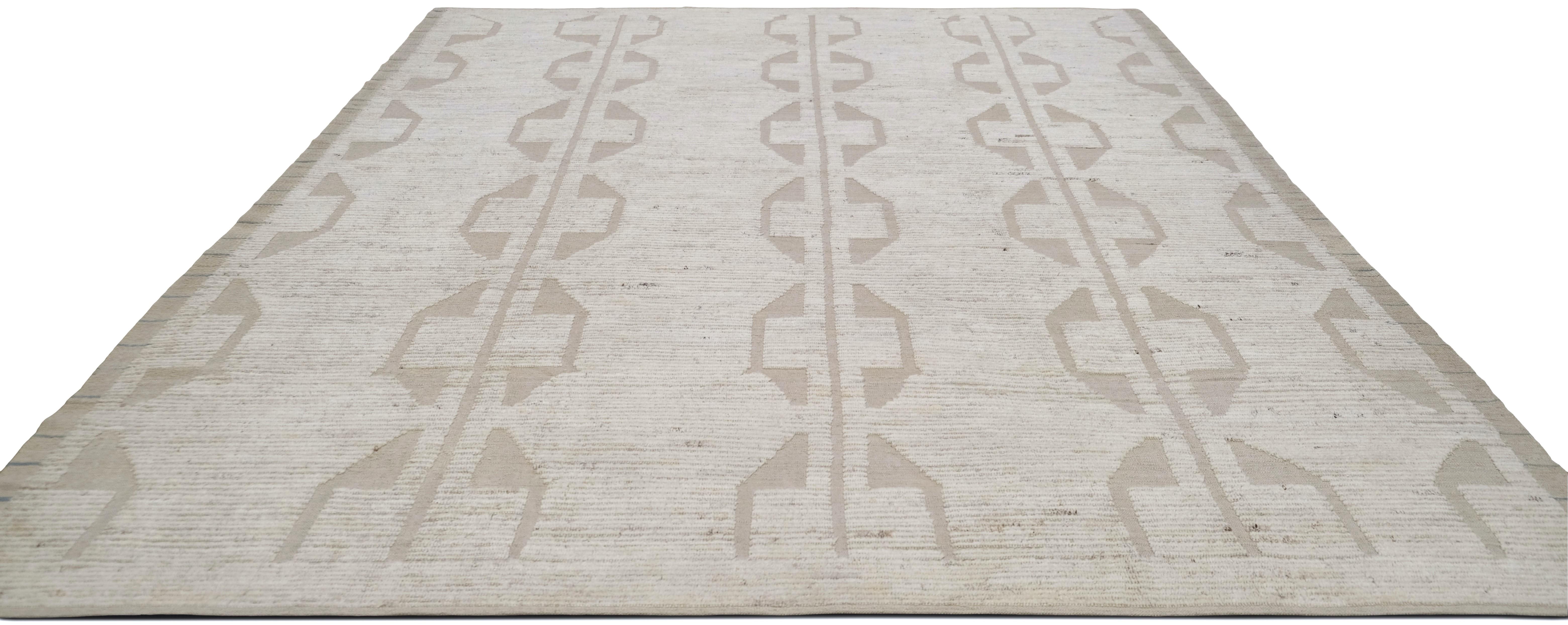 Bring understated elegance to your space with this exquisite hand-knotted wool rug, featuring a modern geometric minimalist design. The sophisticated pattern consists of subtle, abstract linear motifs in a soft beige and ivory palette, creating a