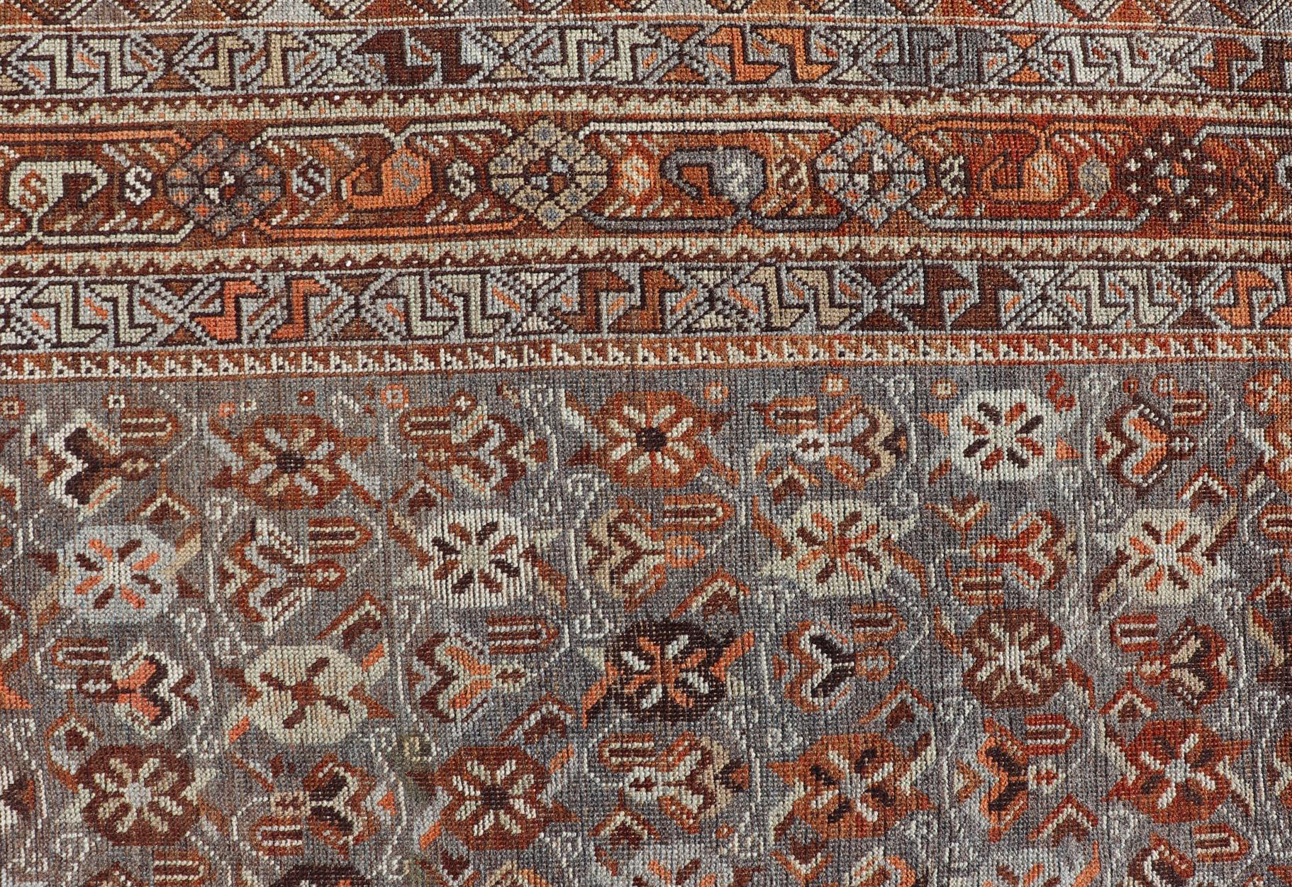 Measures: 6'10 x 9'0 
Geometric Persian Shiraz Rug with Tri-Medallion Design in Shades Orange and Blue. Arts / rug EMB-22132-15042, country of origin / type: Iran / Shiraz, circa 1910.

This Persian Shiraz rug (circa early 20th century) features