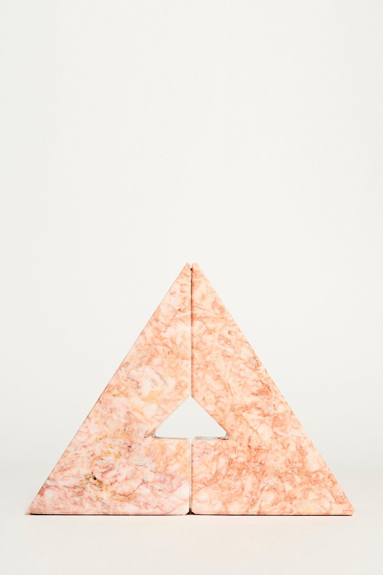 Geometric marble bookends with intricate veining in soft pink and gray.