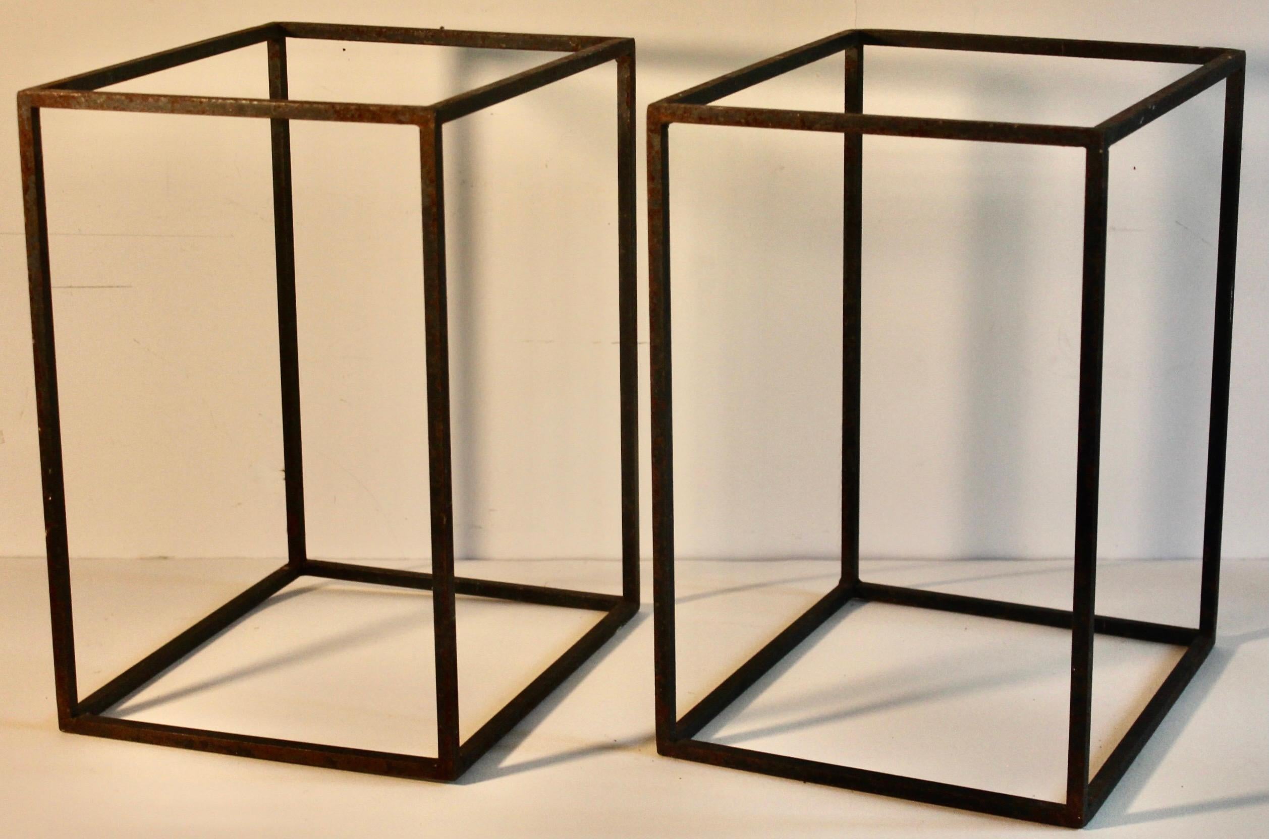 A pair of hand welded square section wrought iron rectangular forms.
Multiple possible positions and tops. 