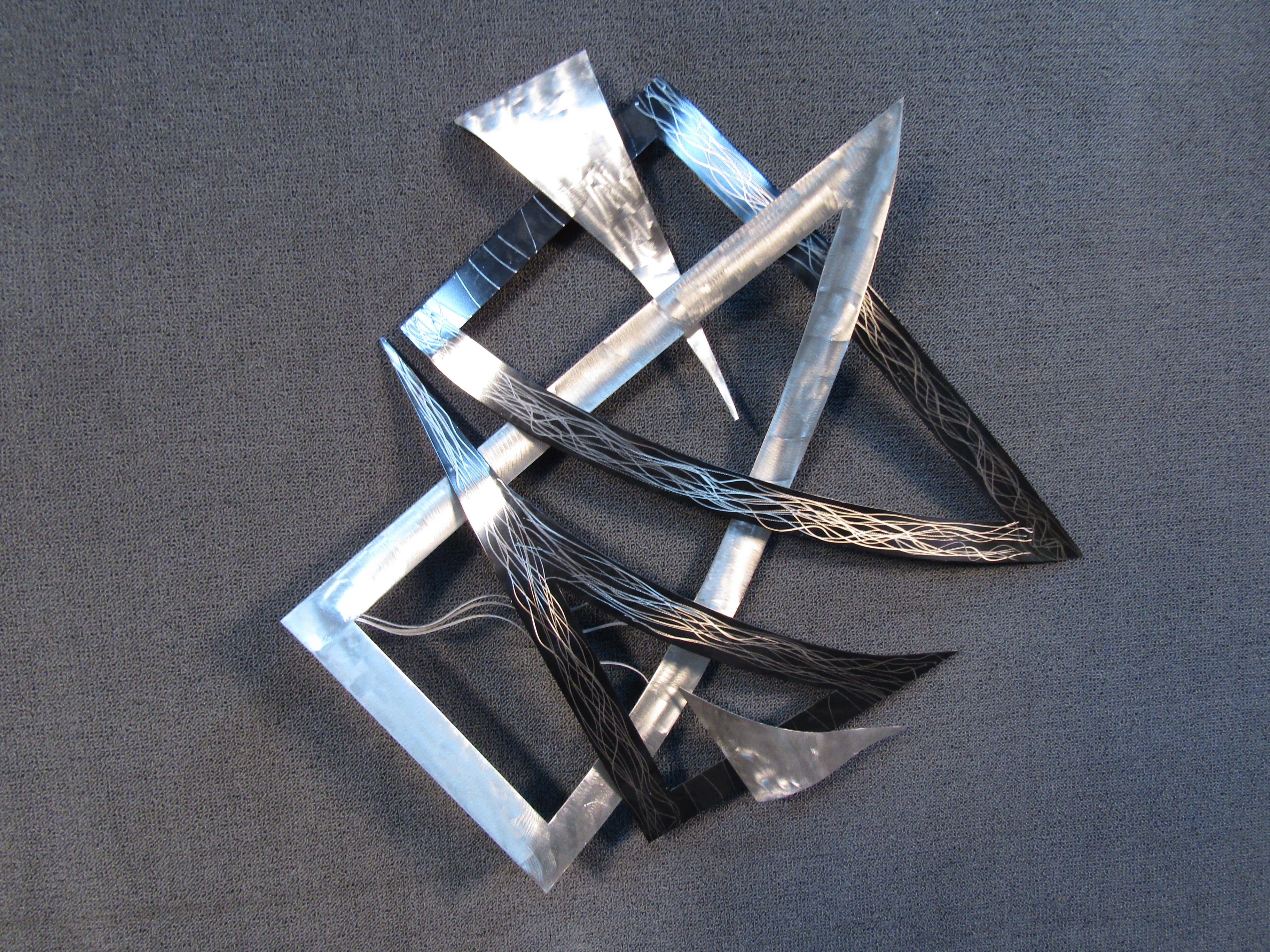 This vintage wall-mounted sculpture by Curtis Jere features geometric pieces of metal arranged in an abstract composition. Please confirm item location with seller (NY/NJ).