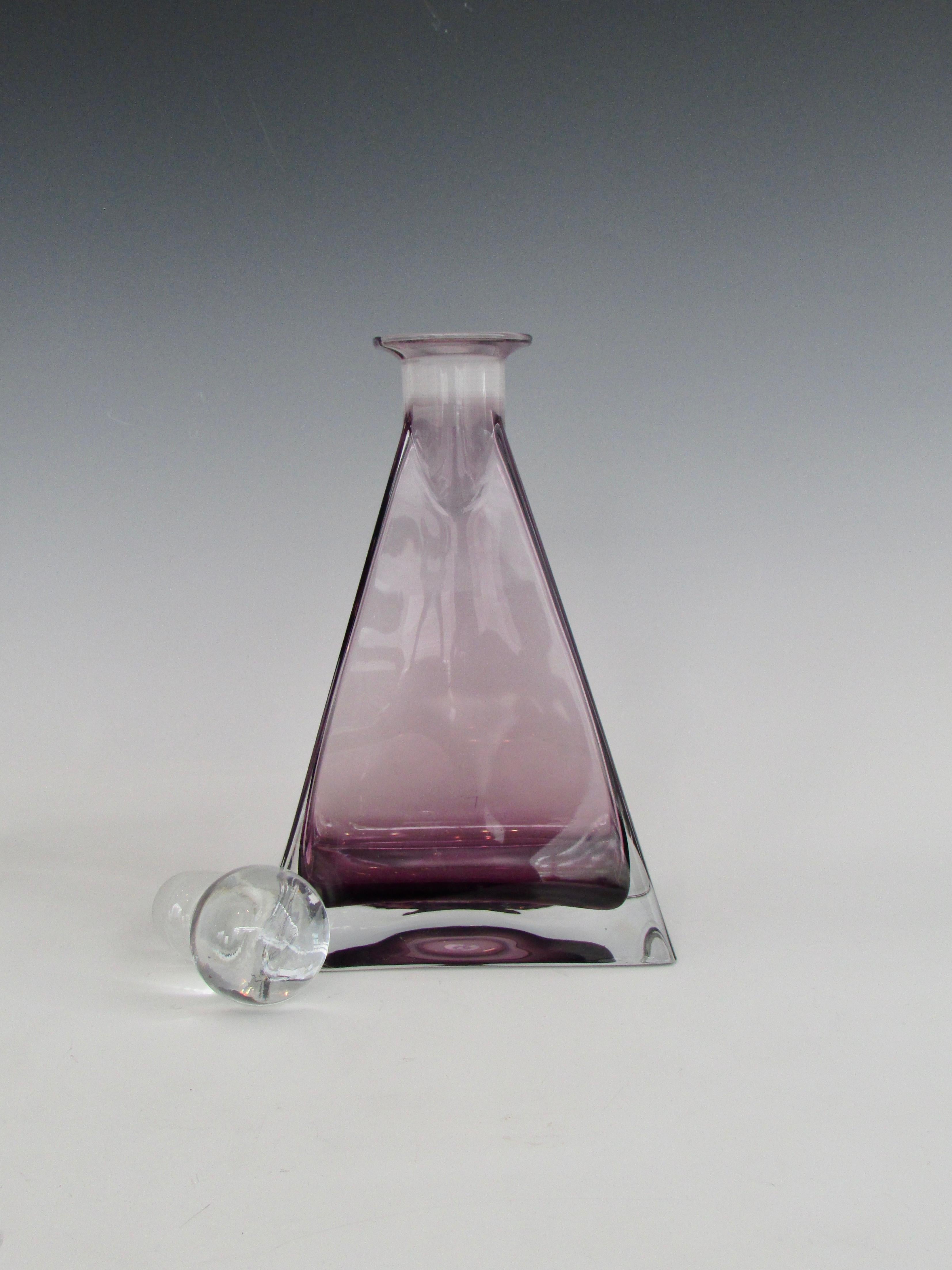 Triangle shaped amethyst glass decanter with clear glass ball stopper.