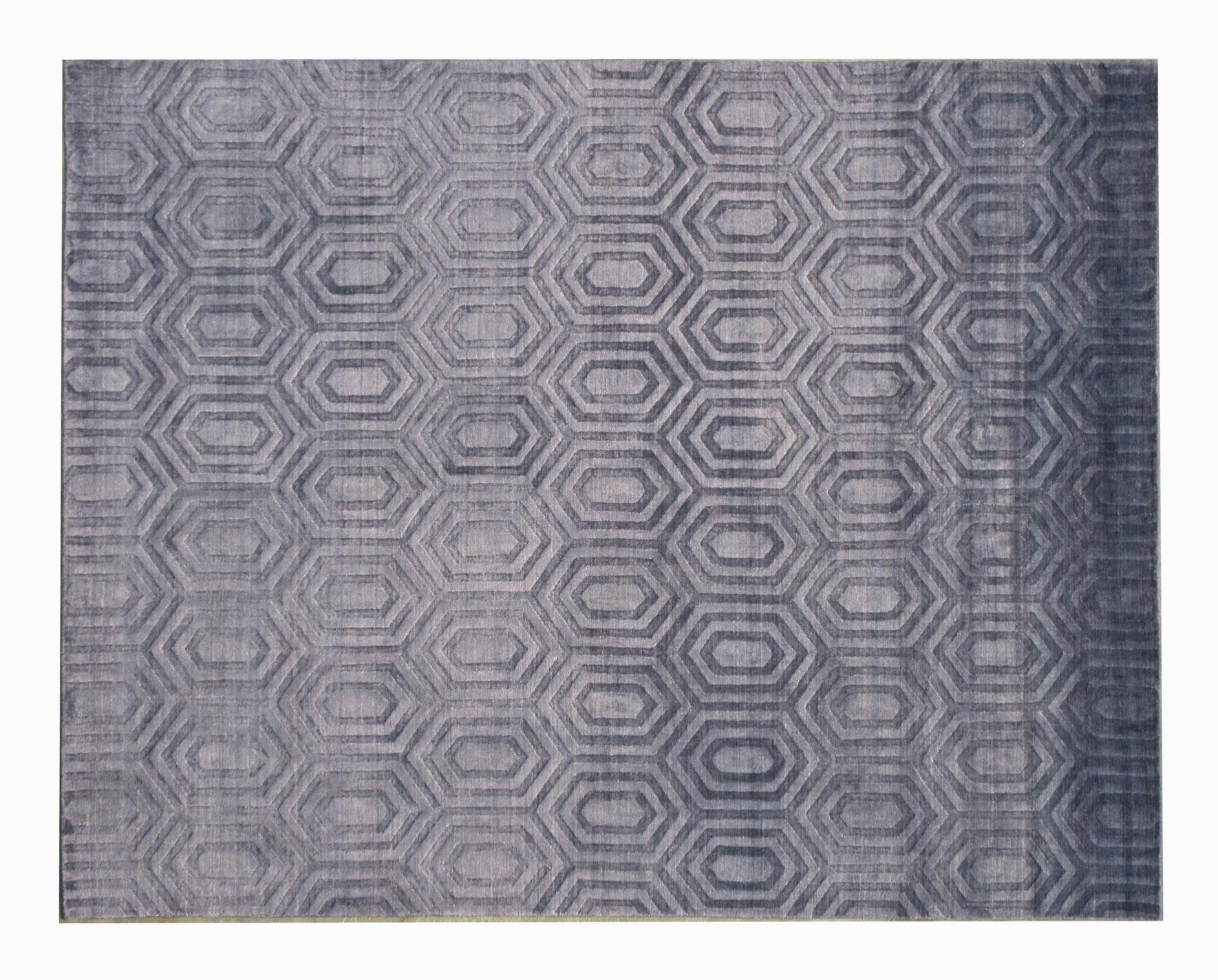 Handmade silk pile on a cotton foundation.

Modern hexagonal geometric design.

Dimensions: 8' x 9'10