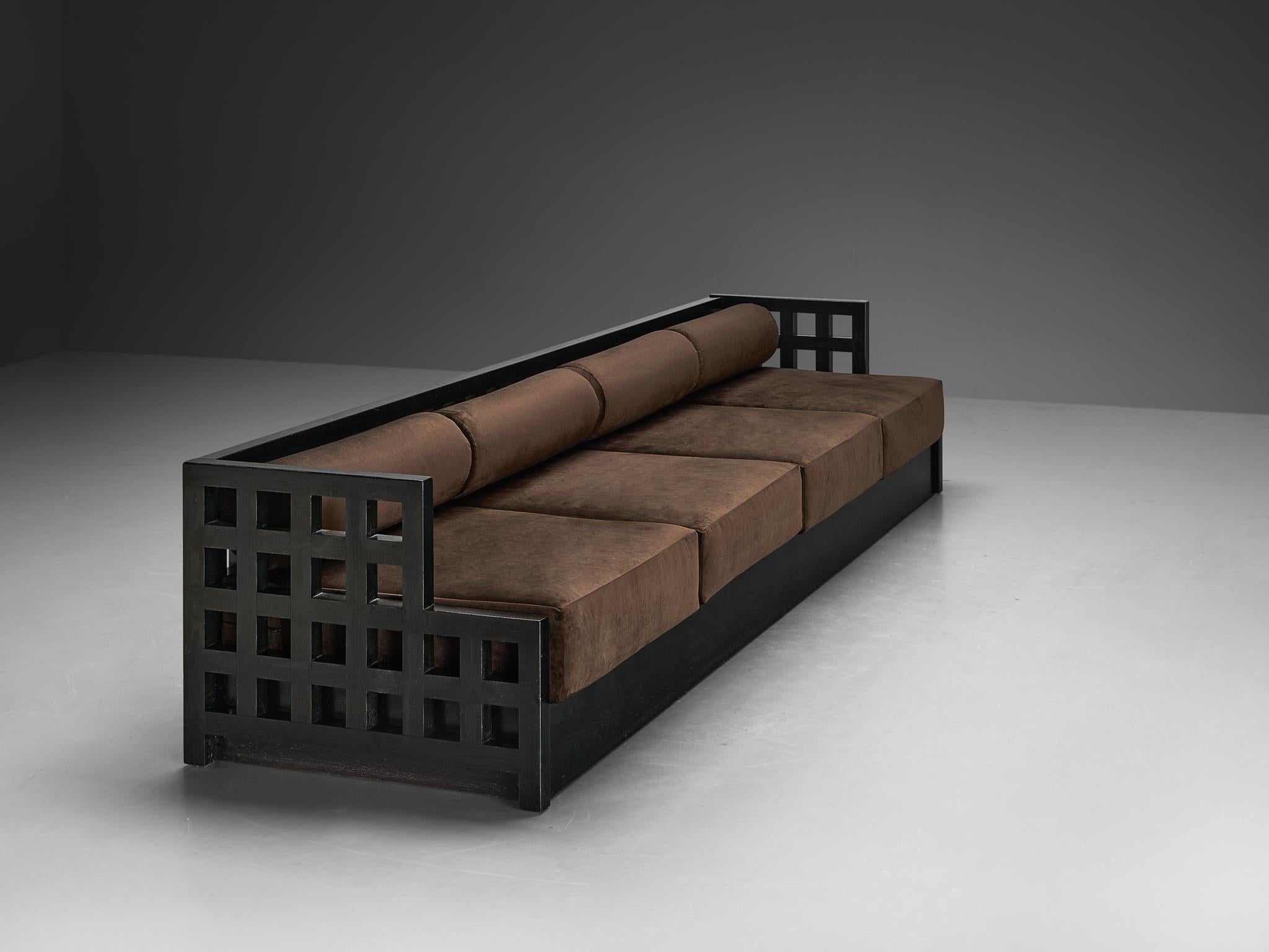 Sofa, lacquered ash, velvet, Europe, 1980s

A visually striking sofa executed in black lacquered ash, its clear geometric structure commands attention, defined by a meticulously arranged grid layout with angular shapes and square apertures. Its