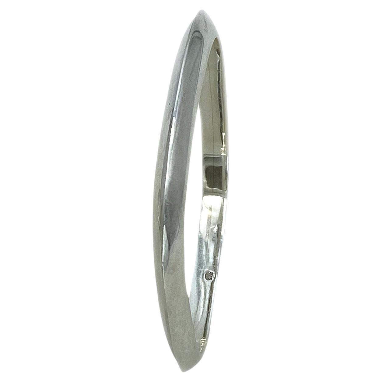 This is a geometric solid sterling silver bangle. This polished bright silver square shaped bangle has round corners and a triangle cross-section. You could have combinations with the other two of the geometric modern bangles in my separate listings