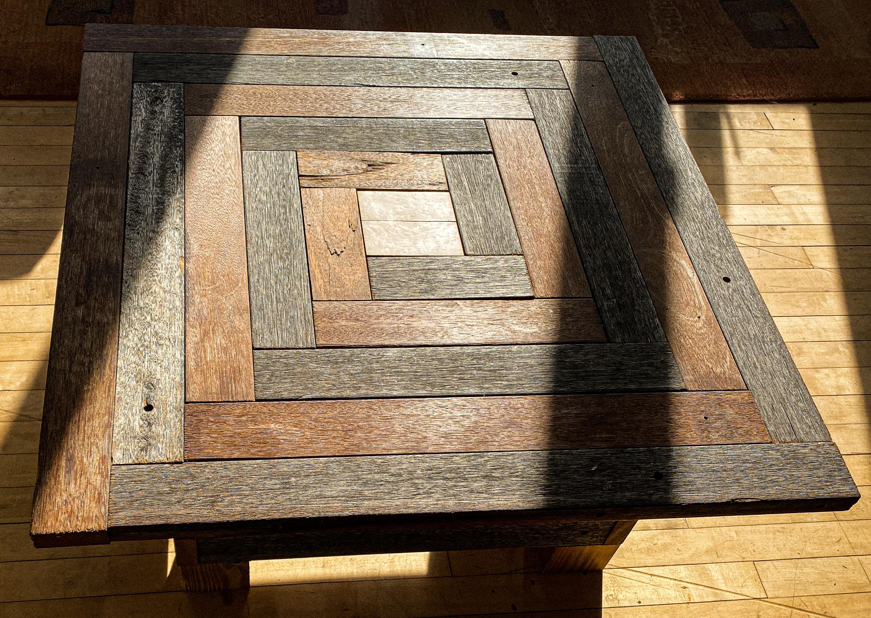 The coffee puzzle table in a labyrinth pattern consisting of mix of weathered and new hardwood strips with a bird’s-eye maple center square.
It's the perfect Arts & Crafts rustic coffee table. A conversation piece in any room.