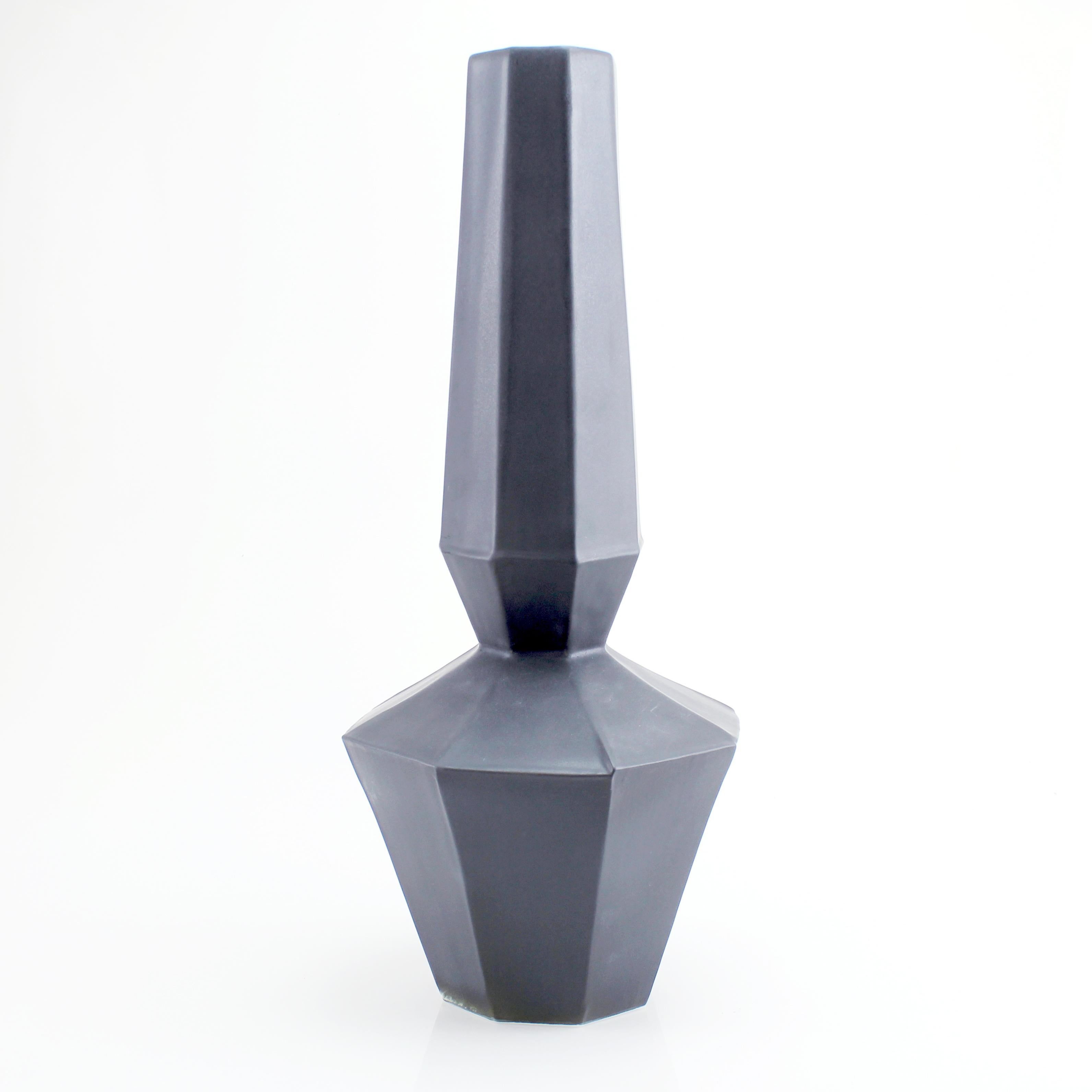 The clean, modern design of the Geometric statement vase offers an updated, elegant look to your room with a Mid-Century Modern feel. This one of a kind piece features a soft matte black glaze. Add a large arrangement of fresh flowers for an