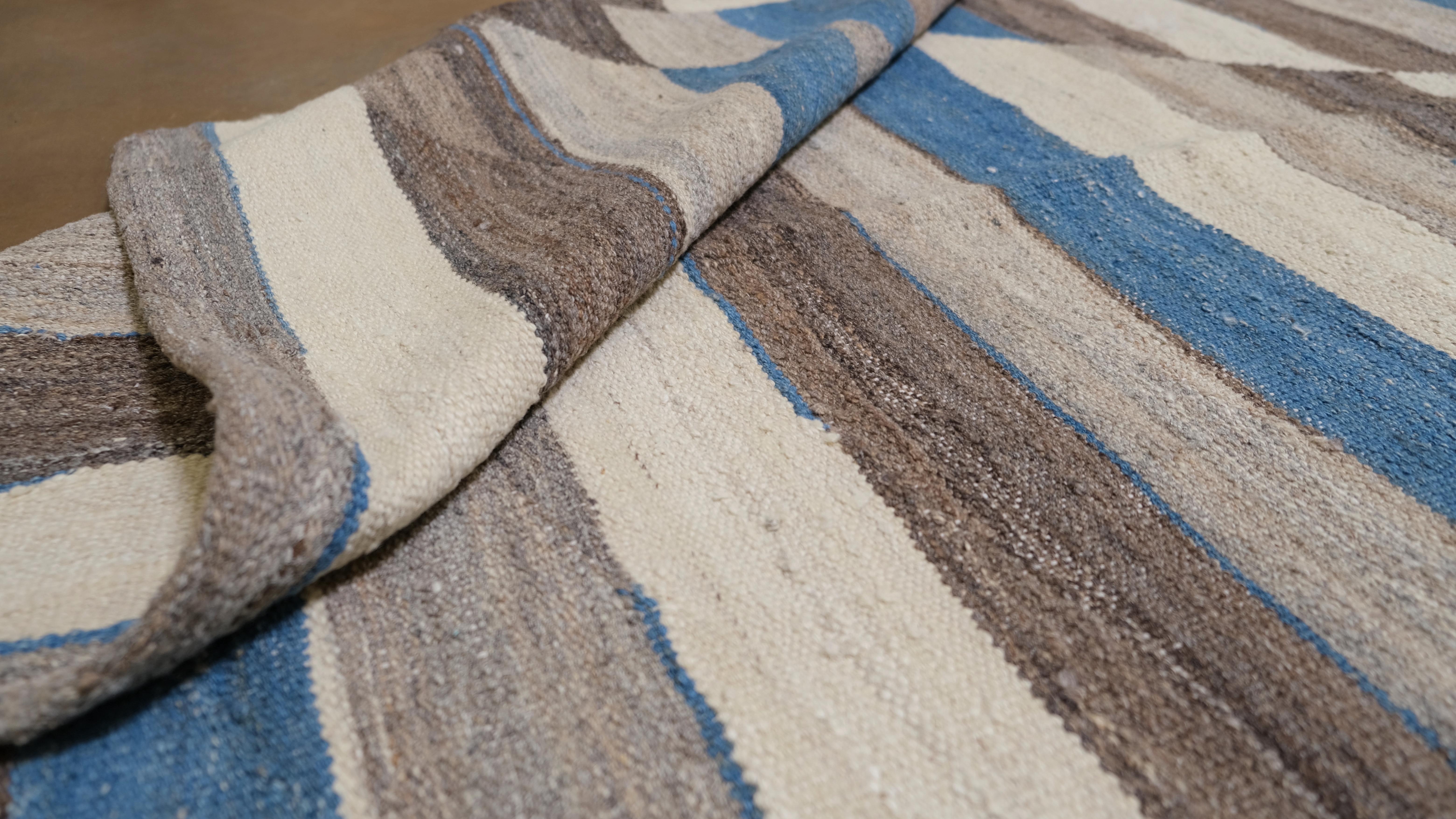 Infusez dans votre intérieur le charme dynamique de ce tapis en laine tissé à la main, doté d'un motif à rayures géométriques saisissant. Mesurant 13'3