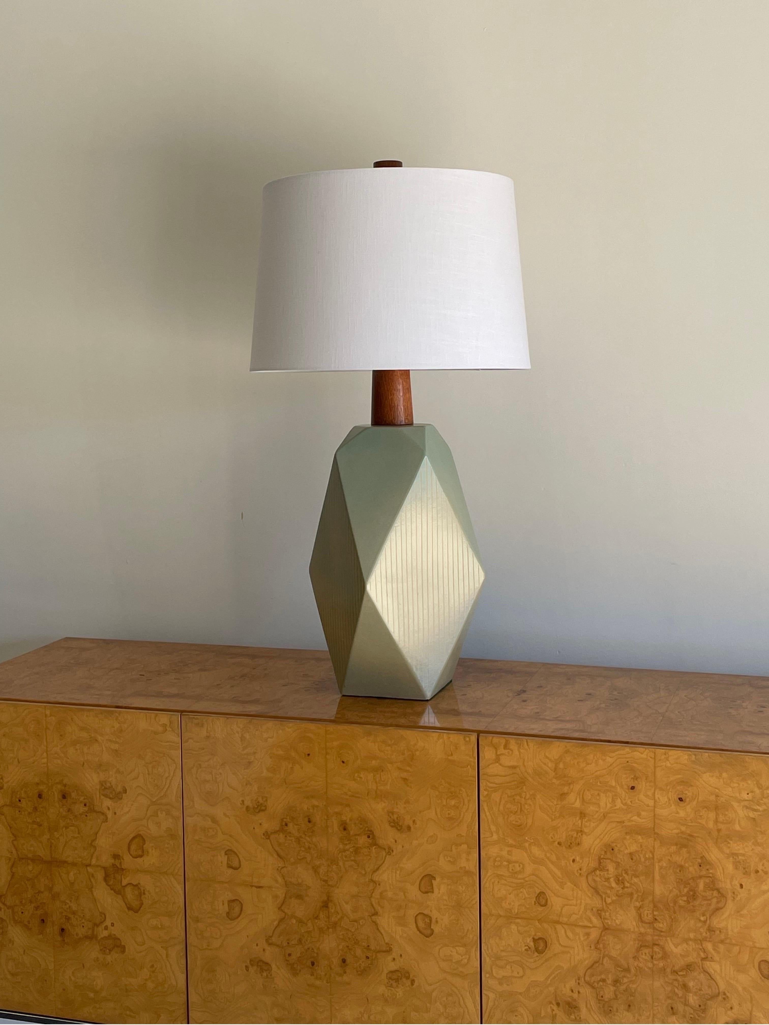 Wonderful and impressive table lamp designed by famed ceramicist duo Jane and Gordon Martz. Color is a sea foam blue/green which is more prevalent towards the top and cascades into a cream at the bottom. 

This particular lamp is signed Genesis