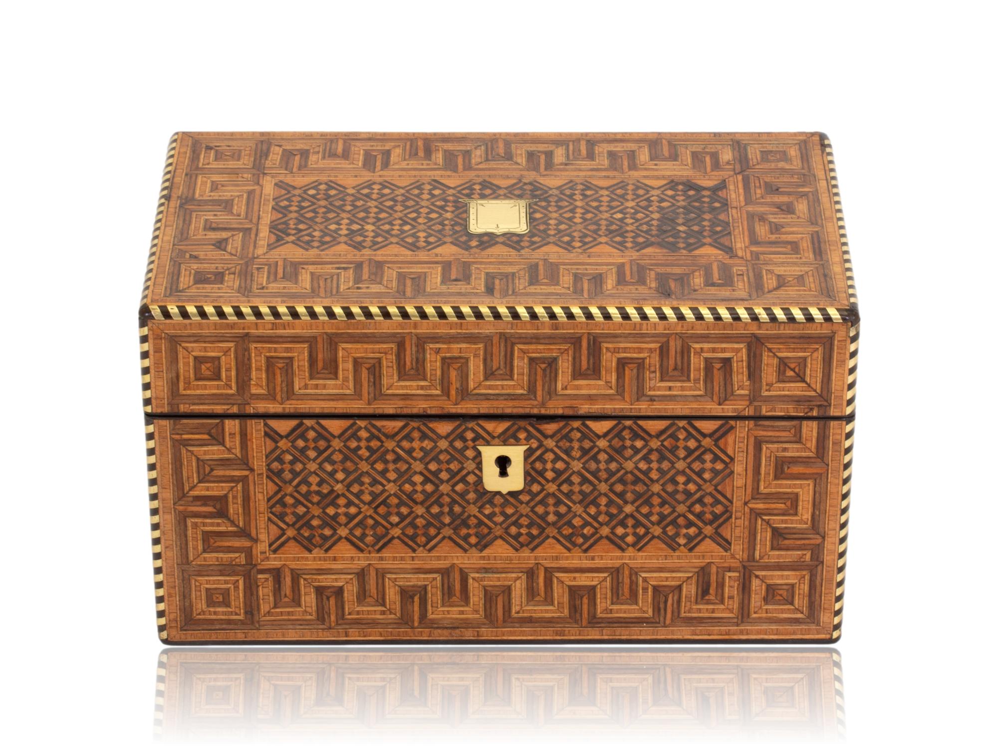 Tunbridge Wear Style 

From our Tea Caddy collection, we are pleased to offer this Geometric inlaid Tea Caddy. The Tea Caddy of rectangular box form is veneered in exotic coromandel to the sides and rear with a front and top panel of various inlaid