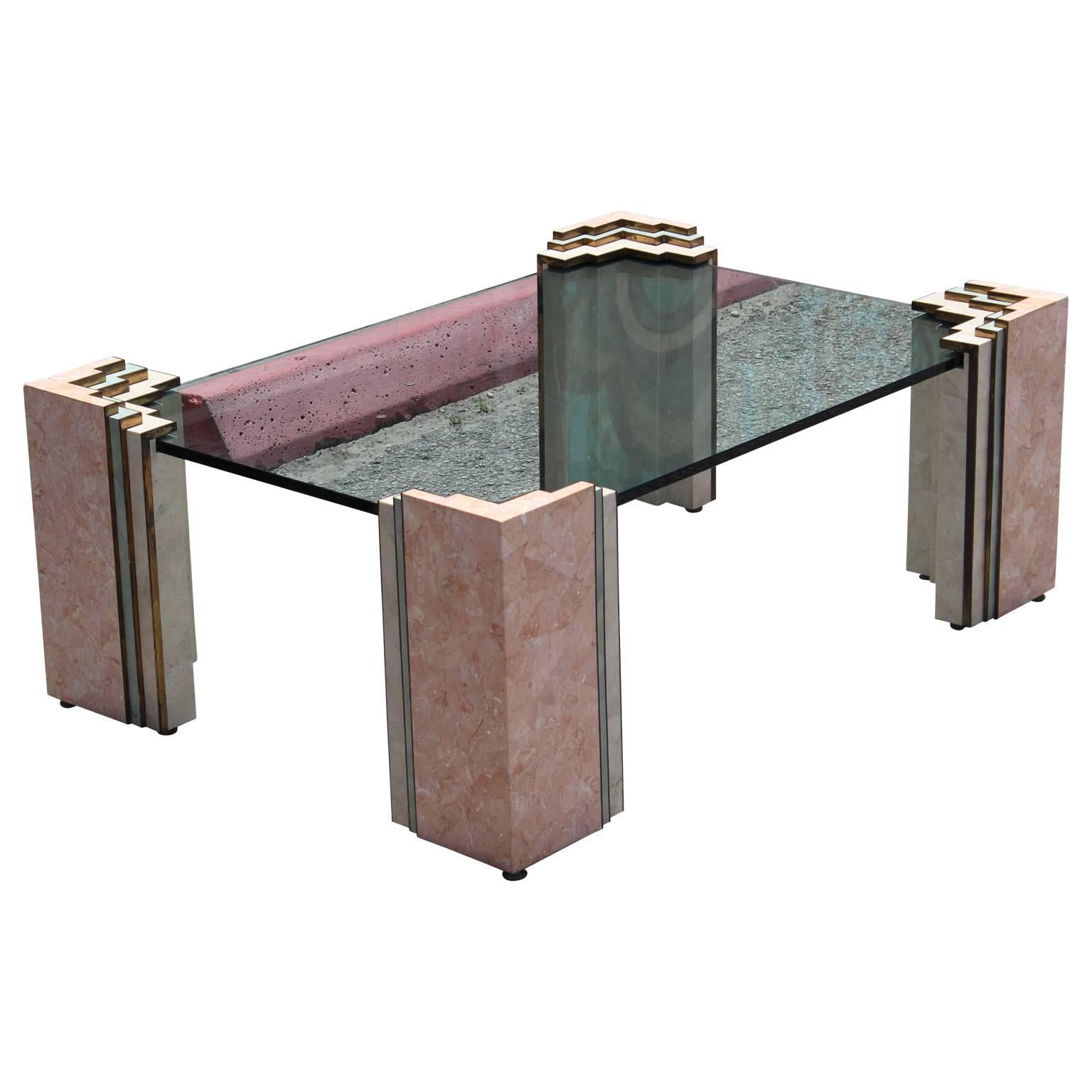 Geometric tessellated fossil marble coffee table by Maitland Smith. Table comes with a custom piece of glass that measures at 42 x 28 inches. Mid-Century Modern coffee table in sky scraper design and geometric patterns with brass detail.