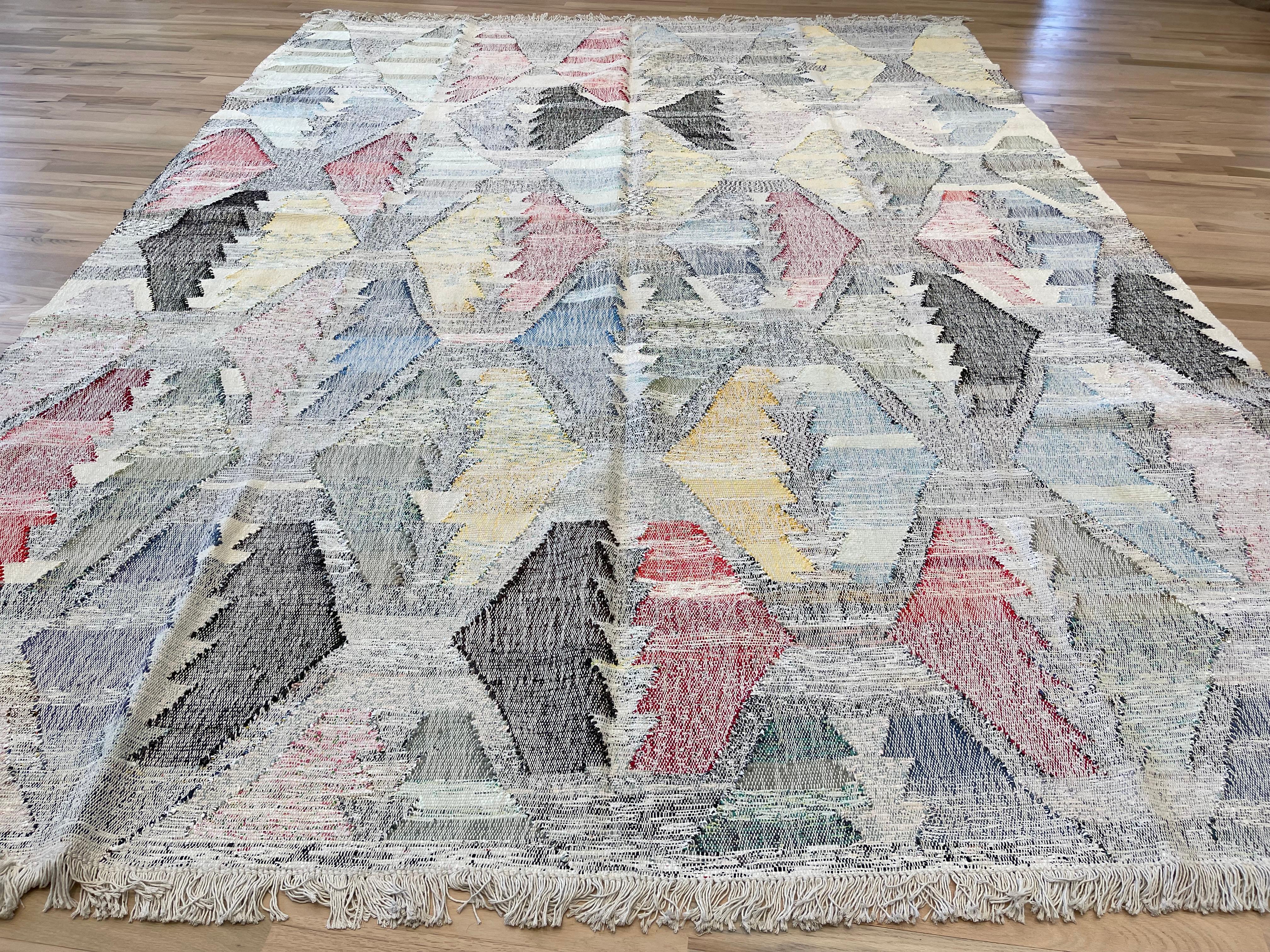 This Turkish rug features a colorful geometric design  allowing you to switch up your decor. Add a touch of style to any room while also having the option to change things up to suit your mood. Beautiful and versatile, this rug is a must-have for
