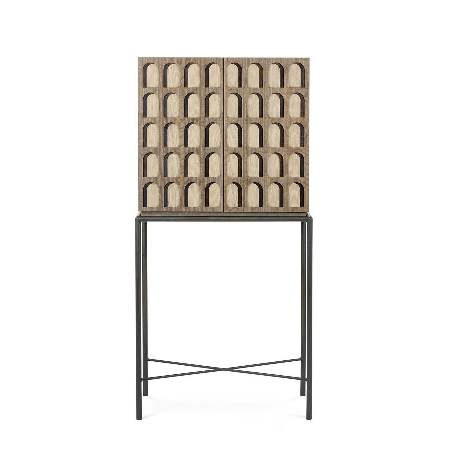 Discover a harmonious blend of natural beauty and architectural detail in this unique two-door cabinet. Its main body is crafted from beautiful, aged eucalyptus wood, chosen for its inherent warmth and the subtle variations in its grain, which lends