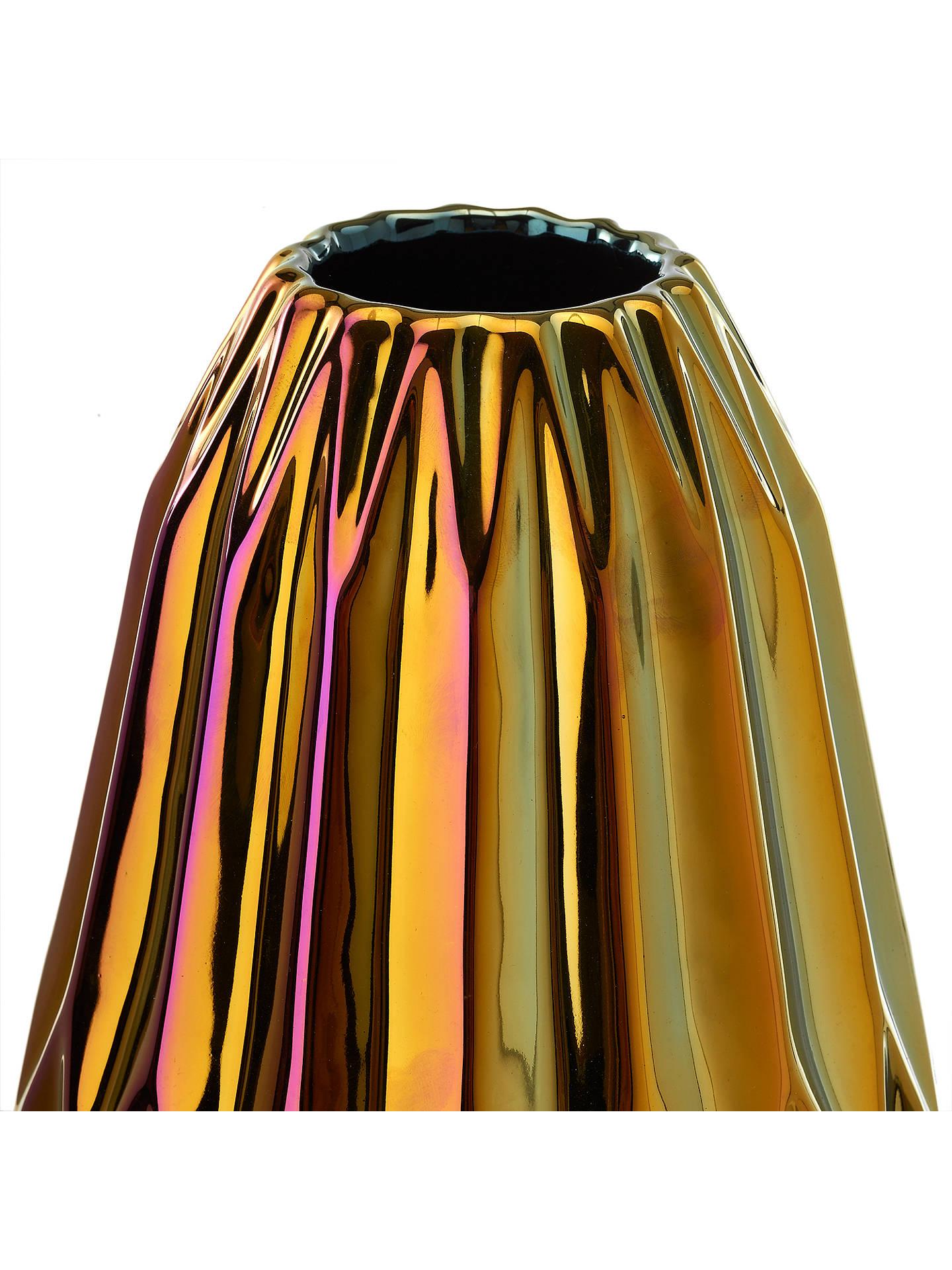 The oily folds vase is a round ceramic vase that has an iridescent finish with a geometric silhouette. The shades of color are effected by different variations of light. Designed and handcrafted in the Netherlands.

Measurements: 13” height x 6.5”