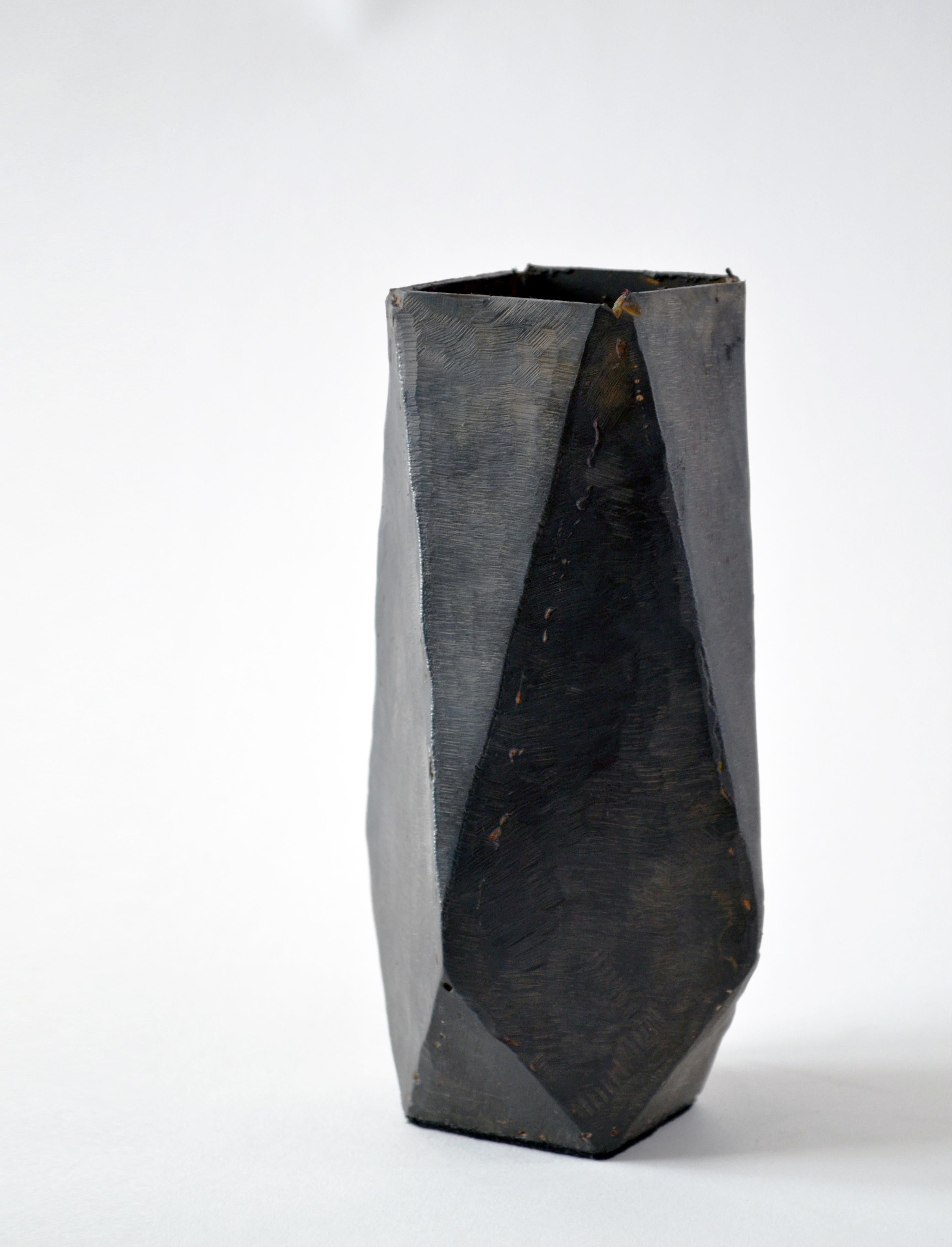 Vessel No 6.
J.M. Szymanski
d. 2017
Blackened and waxed iron

This is a unique architectural object made entirely of iron. J.M. Szymanski uses a unique process of metal sculpting to achieve these dynamic facets. It is finished in a black wax. Not
