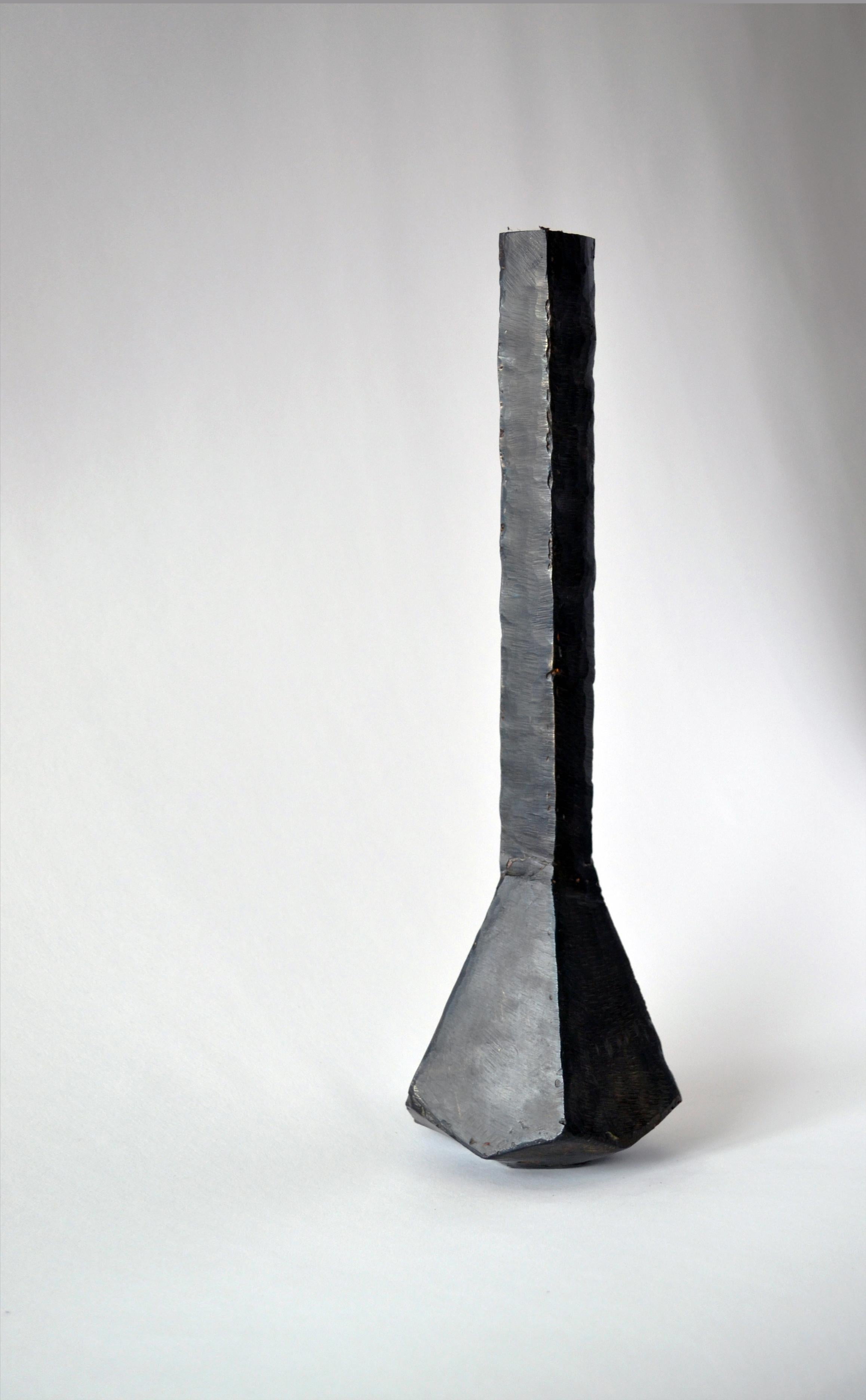 Vessel No 2.
J.M. Szymanski
d. 2017
Blackened and waxed iron

This is a unique architectural object made entirely of iron. J.M. Szymanski uses a unique process of metal sculpting to achieve these dynamic facets. It is finished in a black wax.