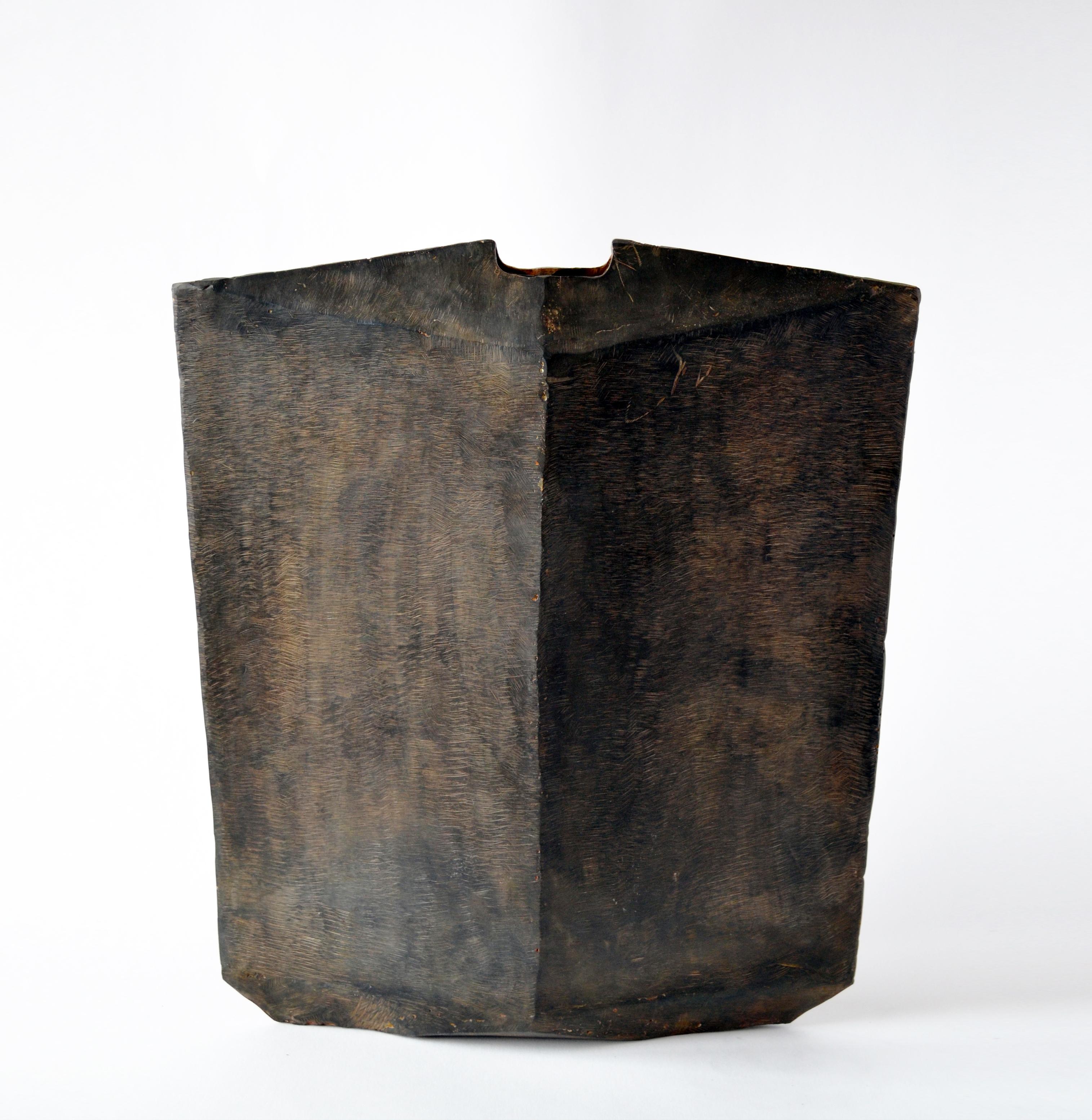 Vessel No 4.
J.M. Szymanski
d. 2017
Blackened and waxed iron

This is a unique architectural object made entirely of iron. J.M. Szymanski uses a unique process of metal sculpting to achieve these dynamic facets. The object is comprised of 18