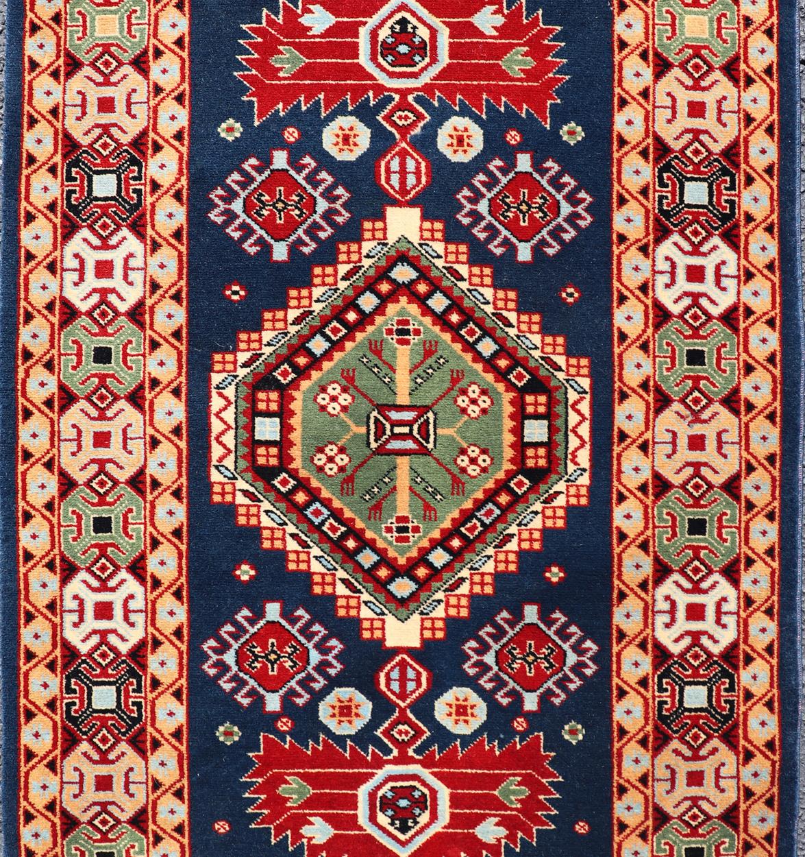 Tribal geometric medallion design vintage rug from Caucasus in multi-colors, rug 10-KE-311, country of origin / type: Caucasus / Tribal, late 20th century

The vibrant reds, blues, and ivories that decorate this beautiful carpet from the late 20th