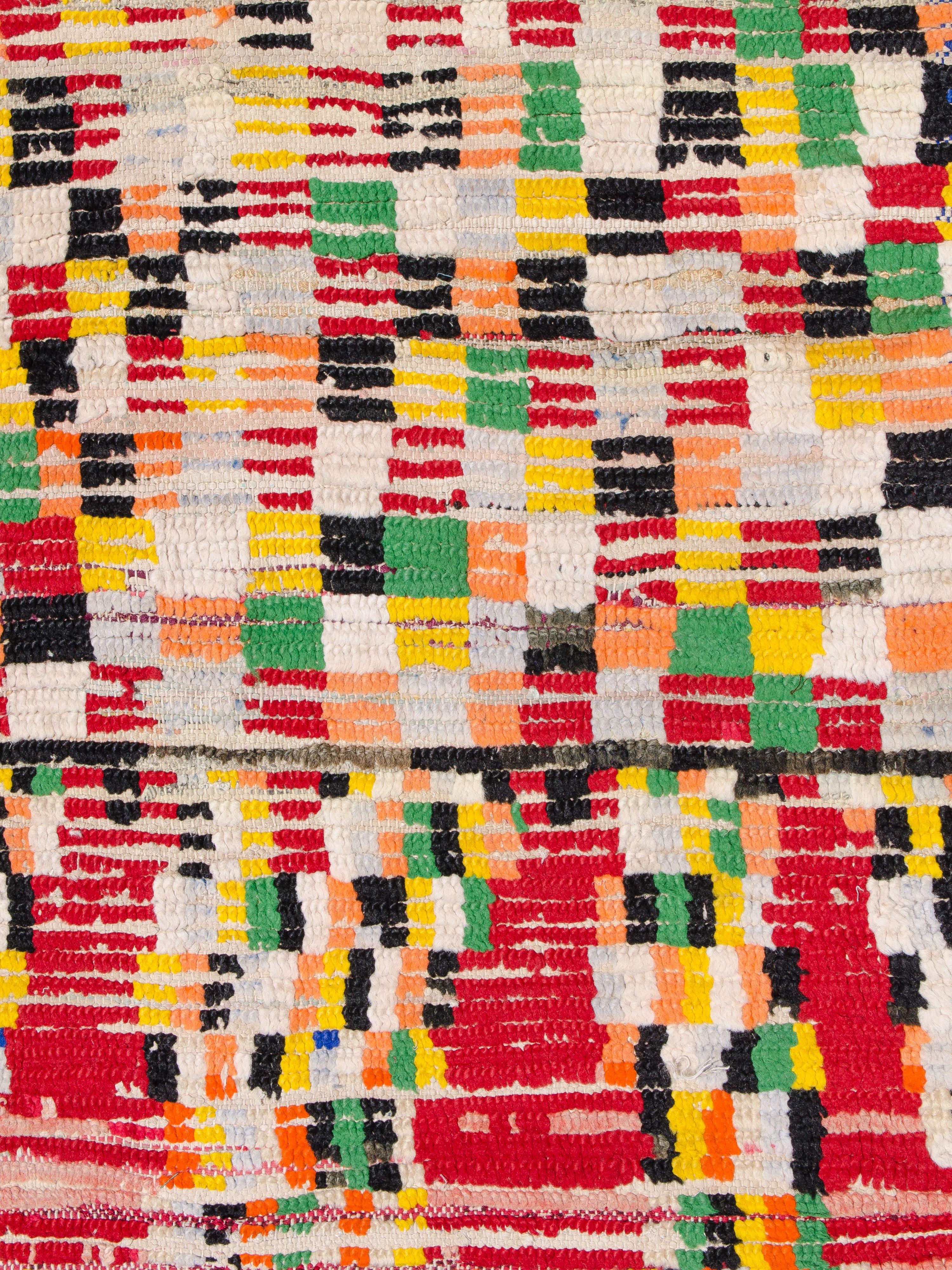 A vibrant study in geometry, composition, and color, this vintage Boujad runner features a checkerboard structure that shifts in scale across the field. An organized grid morphs into various iterations, dissolving at one end. Knotted in a playful
