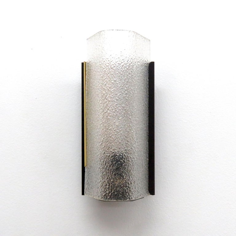 Elegant French wall sconce by Arlus, in brass, enameled metal and textured Lucite.