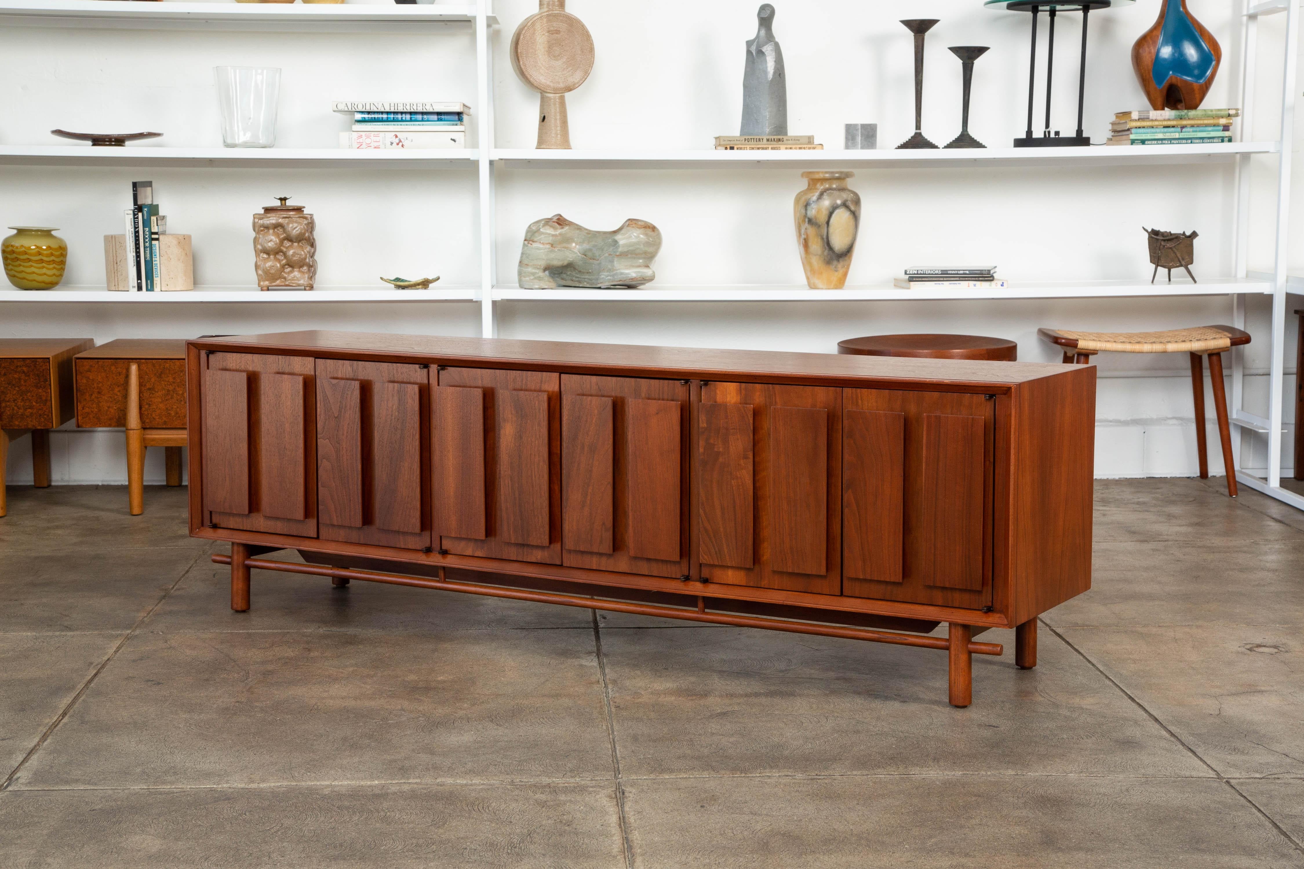 Walnut credenza by Lane Furniture Co., circa 1960s the cabinet features a walnut frame with beautiful grain, featuring three sets of side by side doors. Each door has two rectangular walnut panels decorating the front. The inside compartments have
