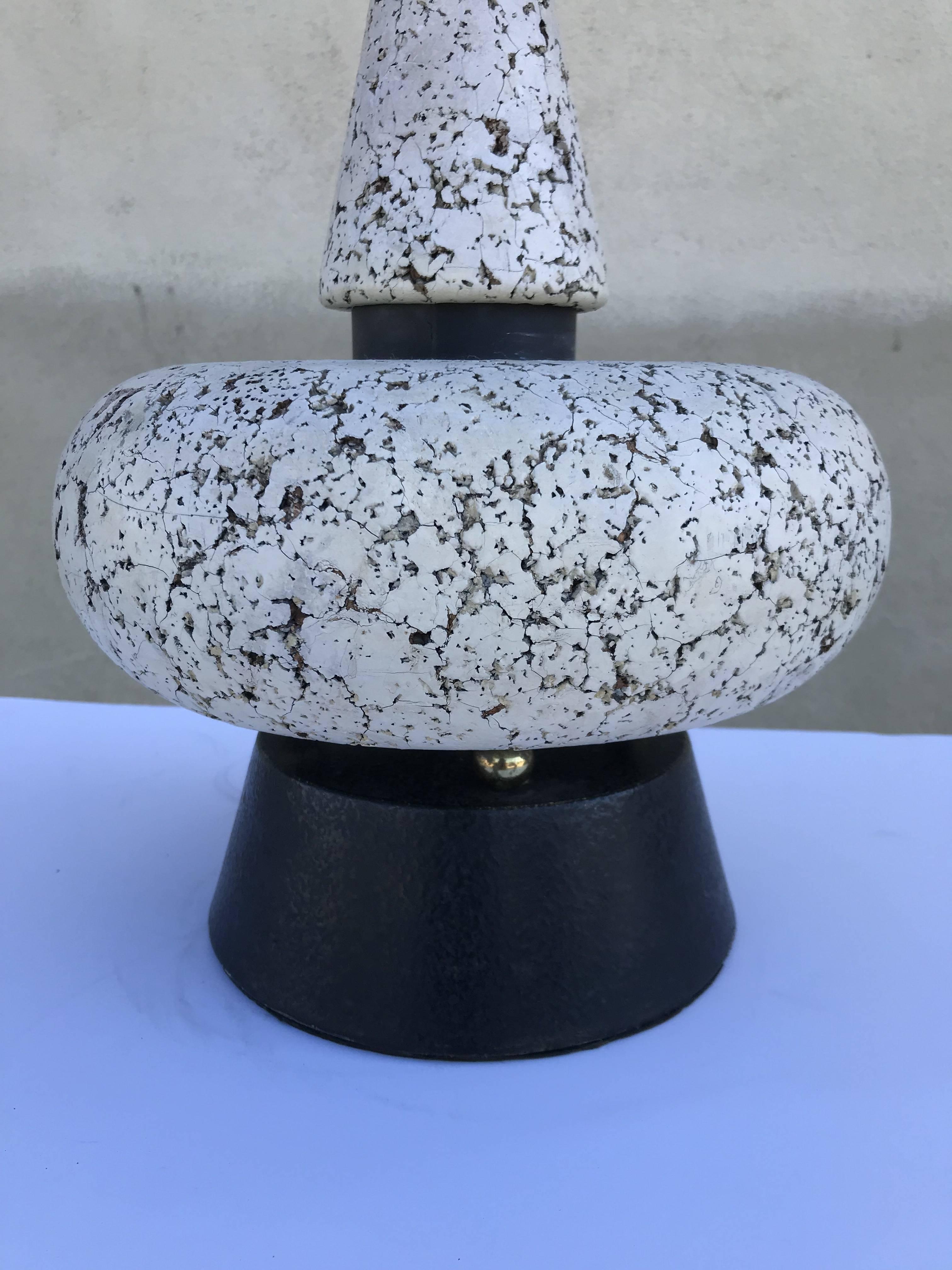 Rare table lamp is made several different geometric shapes of white cork, black painted metal and brass. Measures 34.5