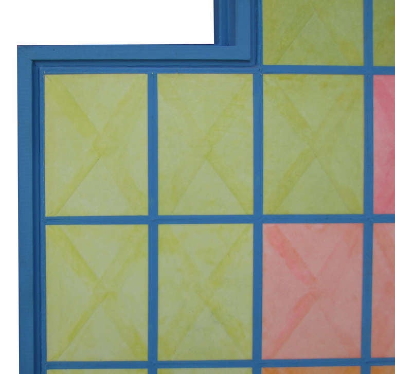 This piece features corner cut-outs that beautifully adhere to the geometric theme of the work itself. It comes in an original wood frame painted blue. 
Signed on verso, 