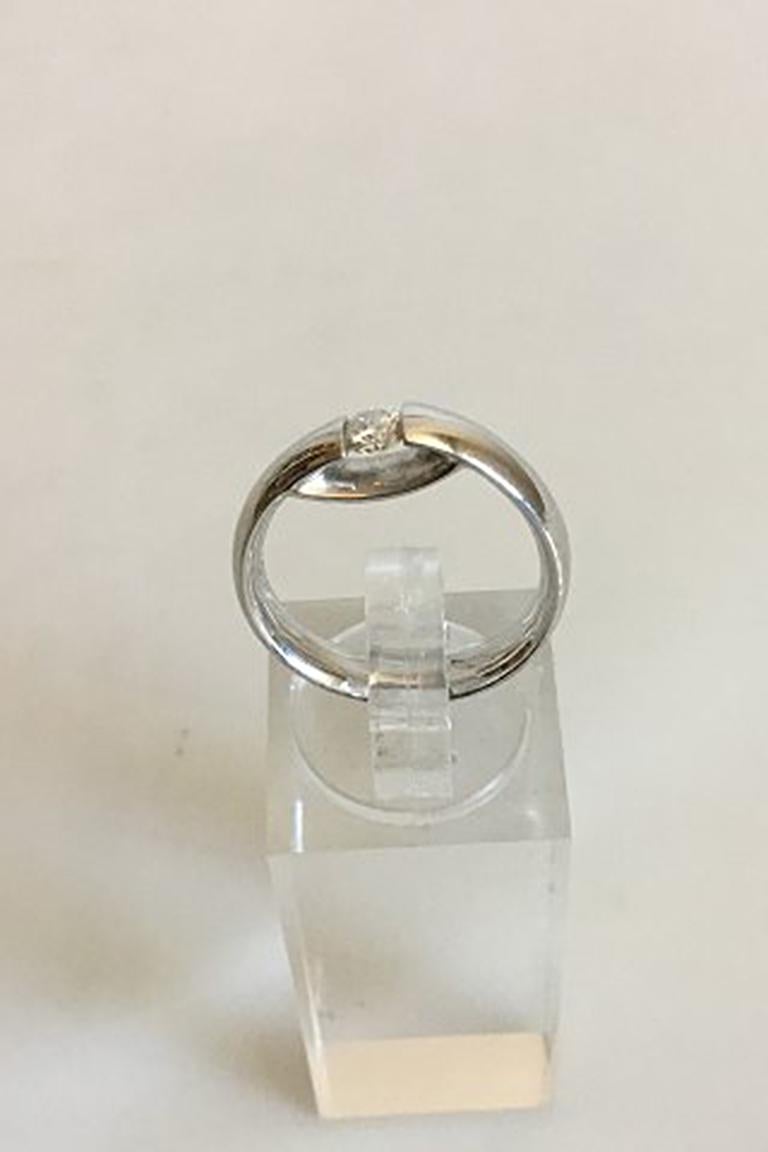 Georg Jensen 14 K 750 White Gold Centenary Ring with Brilliant cut Diamond 0.20 carat. Designed by Kim Buck. Ring Size 52 / US 6. Weighs 5.5 g / 0.20 oz.