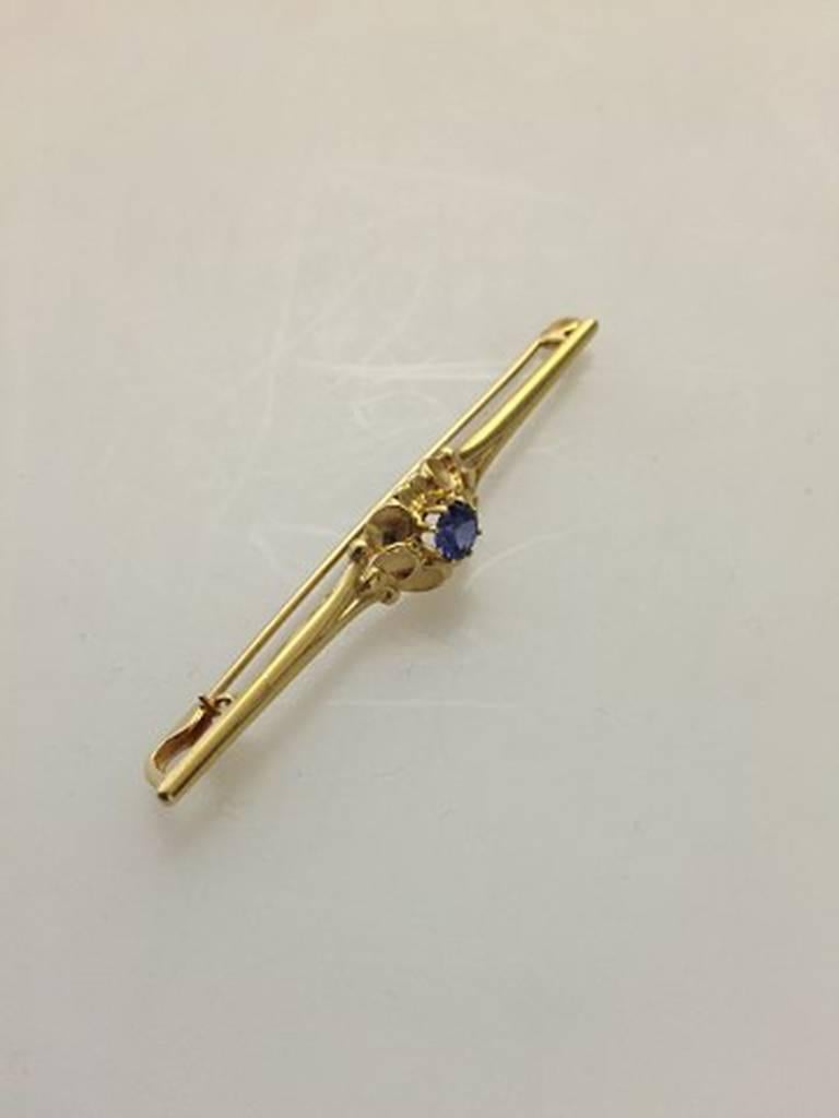 Georg Jensen 18K Gold Brooch with Synthetic Sapphire #281. Measures 5.8 cm L (2 9/32 in.). 1 cm W (0 25/64 in.)