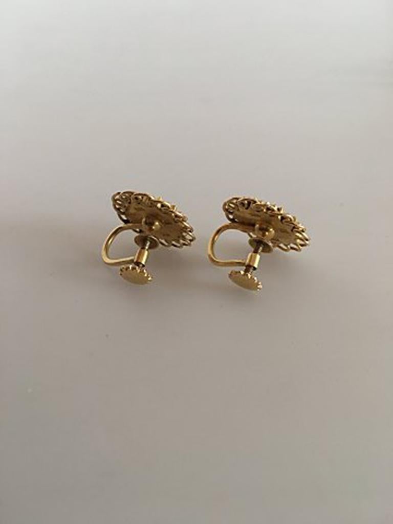 Georg Jensen 18K Gold Earrings (Screws) ornamented with a Pearl. Measures 1.5 cm / 0 19/32 in. diameter. Combined weight of 7 g / 0.25 oz.