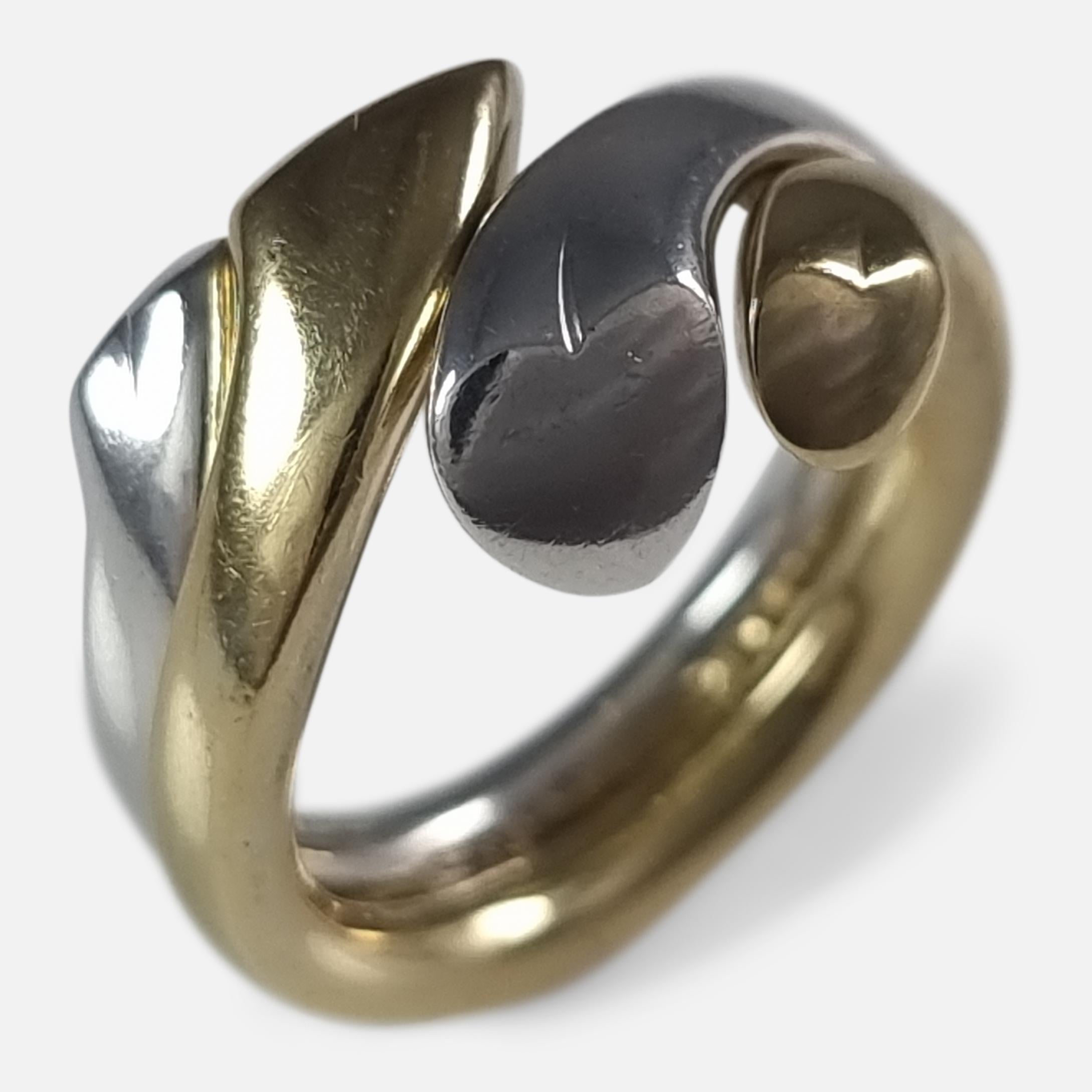 An 18 carat yellow gold and sterling silver 'Devoted Heart' ring, #1262 & #262, designed by Regitze Overgaard for Georg Jensen.

The two part ring is stamped with post 1945 Georg Jensen marks. 

Assay: - The gold ring is hallmarked with the Common