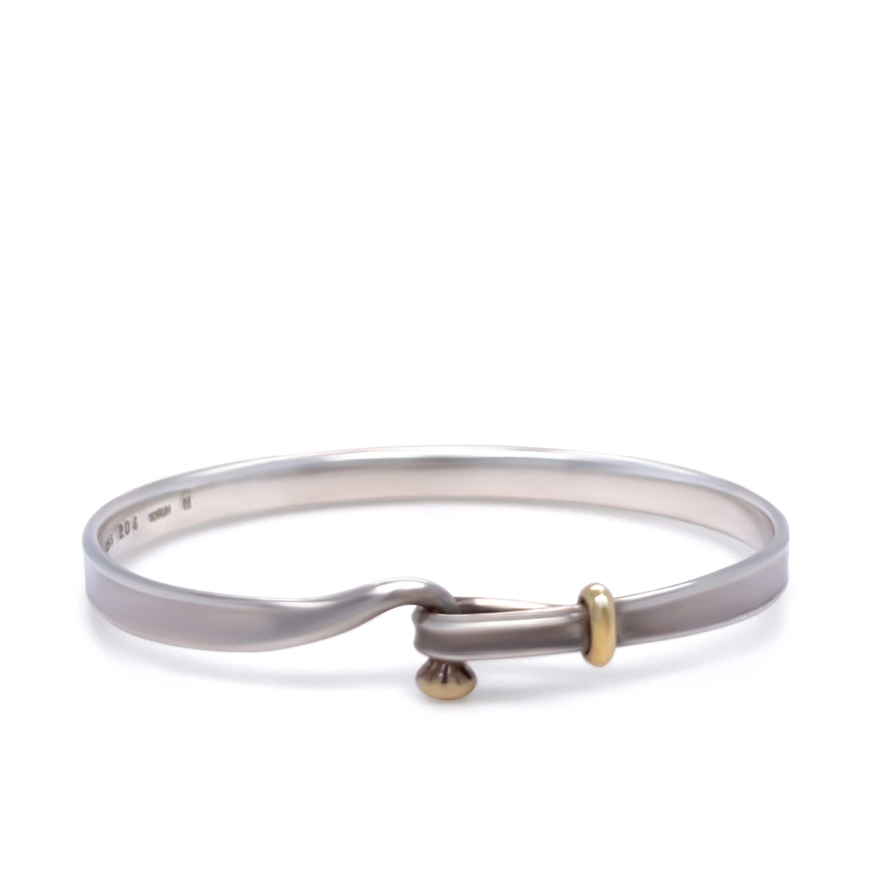 A Georg Jensen Danish Bangle, made of 18ct Gold and 925 Sterling Silver.

Metal: 18ct Gold & 925 Sterling Silver
Carat: N/A
Colour: N/A
Clarity: N/A
Cut: N/A
Weight: 16.72 grams
Engravings/Markings: Signed 925 S 204 750.

Size/Measurement: Size