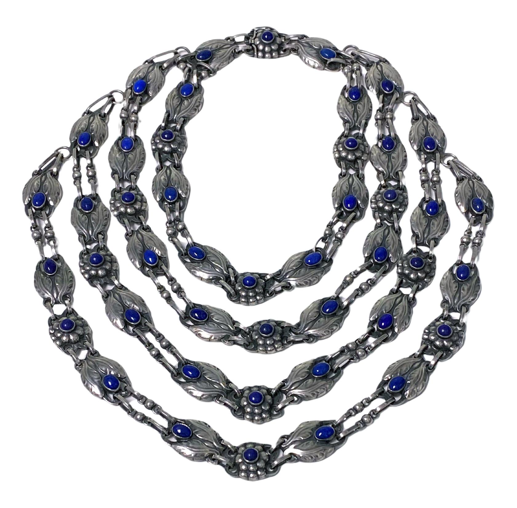 Very rare collectors piece Georg Jensen Lapis and Sterling Silver Necklace, four-tiered graduated strand design No 1, C.1933. Bezel set oval and round lapis with stylised bud leaves and berries interval links. Full Jensen marks and GI marks to