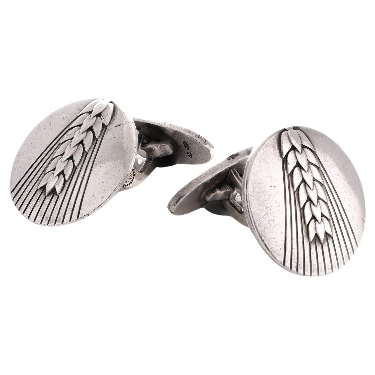Georg Jensen sterling 925 silver pair of cufflinks, featuring a wheat design #78B
Created by Arno Malinowski for Georg Jensen
This particular design is no longer being manufactured.
Made in Denmark, Imported to United kingdom, 1955 
Hallmarked with