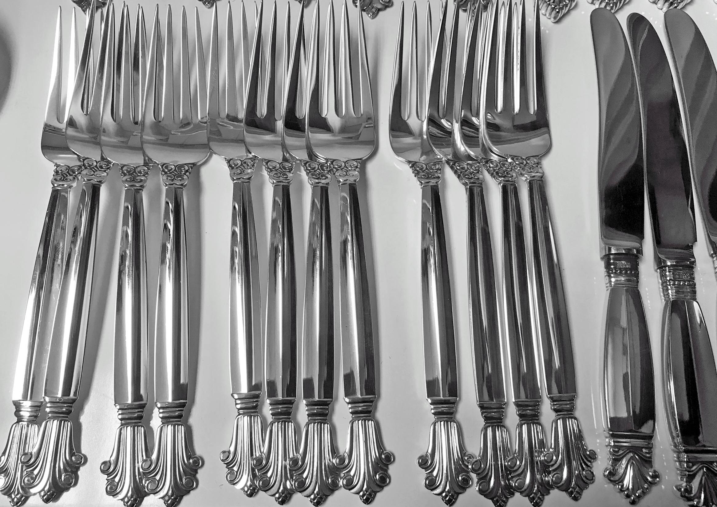 Acanthus by Georg Jensen sterling silver flatware set, 72 pieces. this set includes: 12 dinner knives (9 inch), 12 dinner forks (7 1/8 inch), 12 salad forks ( 6 1/8 inch), 12 dessert spoons (6 1/8 inch), 12 larger spoons (6 7/8 inches), 12 butter