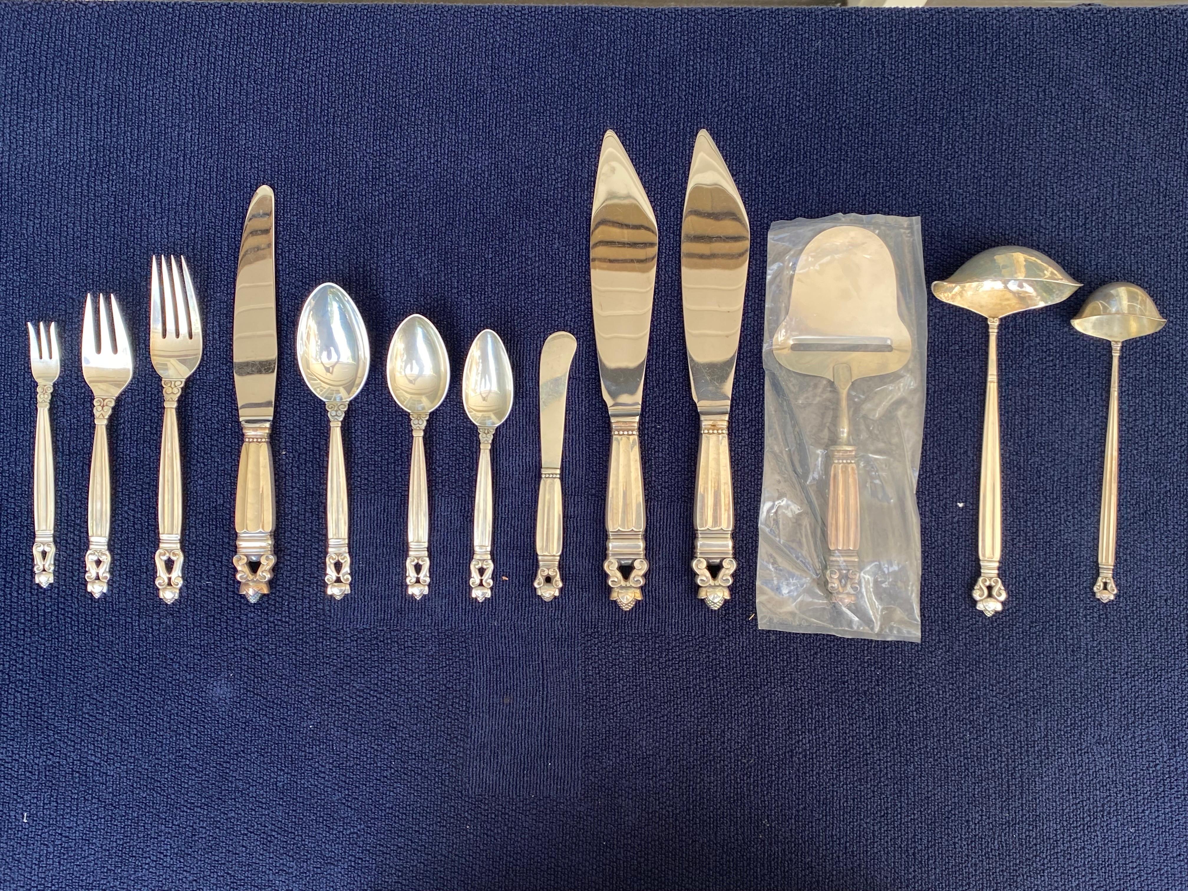 Georg Jensen Acorn Pattern Sterling Silver Flatware, 10-12 Service, 94 Pieces (set not complete). Made by Georg Jensen in Copenhagen. Designed by Johan Rohde. 
Dinner knives, Cake Knives and Cheese plane have stainless steel blades. Butter knives