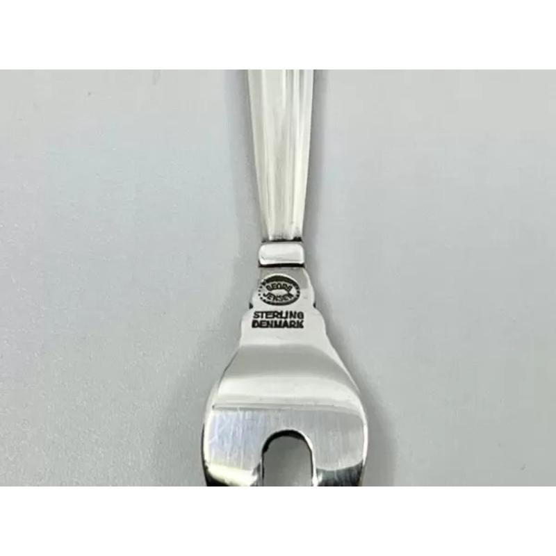 A Georg Jensen sterling silver cocktail fork, item #285 in the Acorn Pattern, flatware design #62 by Johan Rohde from 1915.

Additional Information:
Material: Sterling Silver
Style: Art Nouveau
Hallmarks: With Georg Jensen hallmark, made in