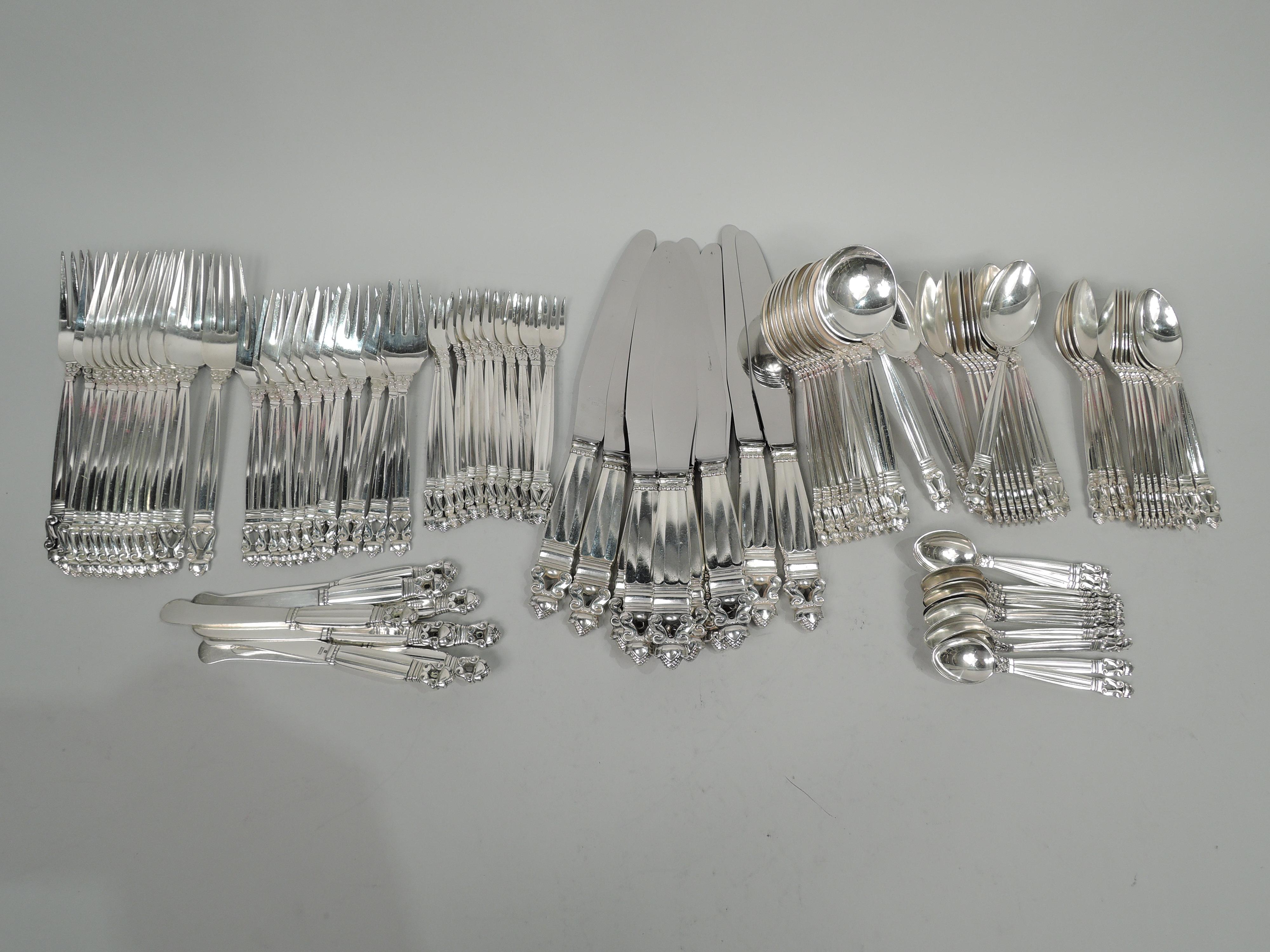 Acorn sterling silver dinner set. Made by Georg Jensen in Copenhagen. This set comprises 104 pieces (dimensions in inches):

Forks: 12 dinner forks (7 3/4), 12 salad forks (6 5/8), and 12 seafood forks (5 5/8);

Spoons: 12 teaspoons (6 1/8), 12