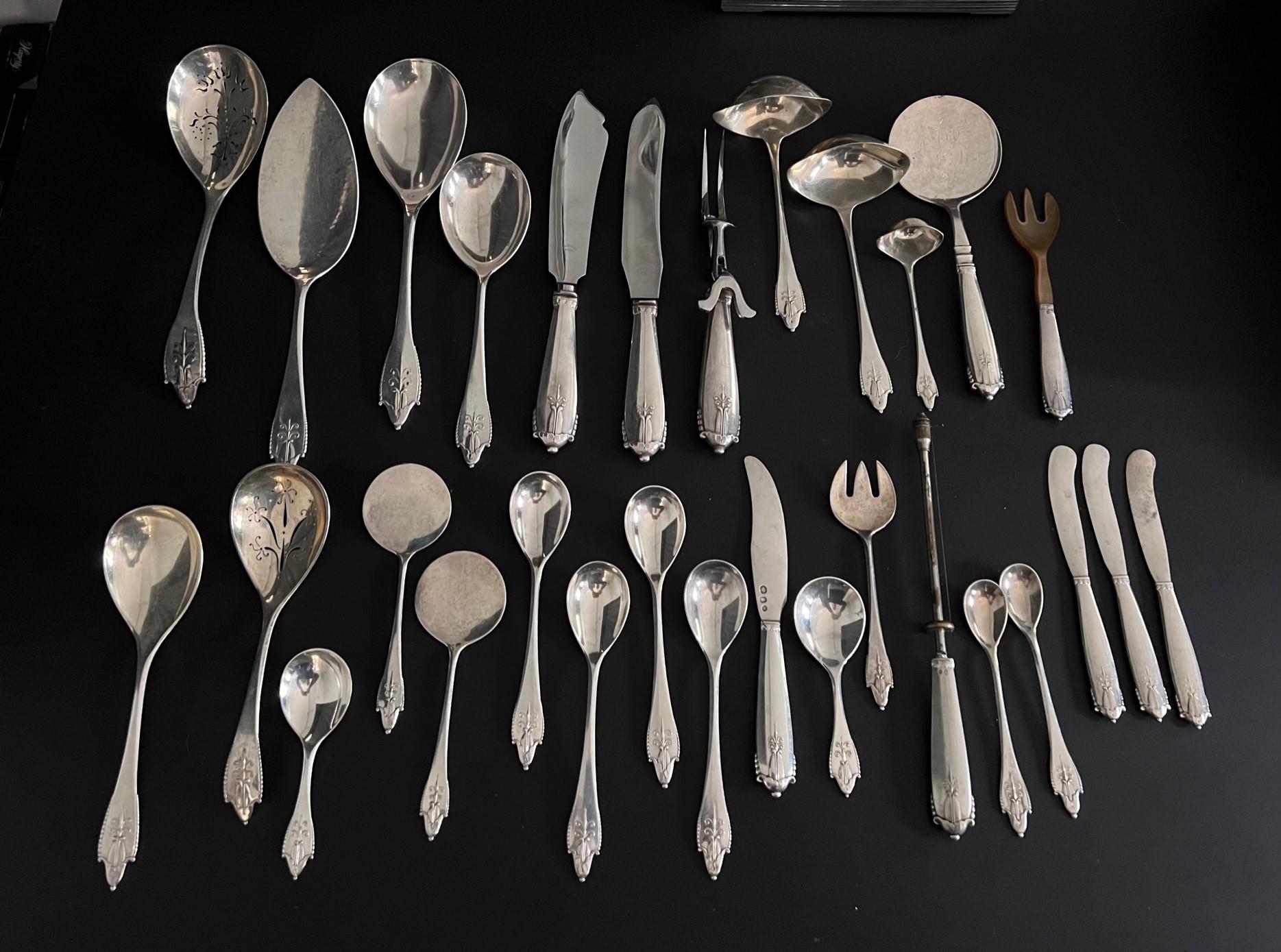 A very early and extensive Georg Jensen silverware service in the Akkeleje pattern, design #77 by Georg Jensen from 1918. Its unusual to find a large complete set in this pattern, it is more unusual that nearly all the pieces were bought and are