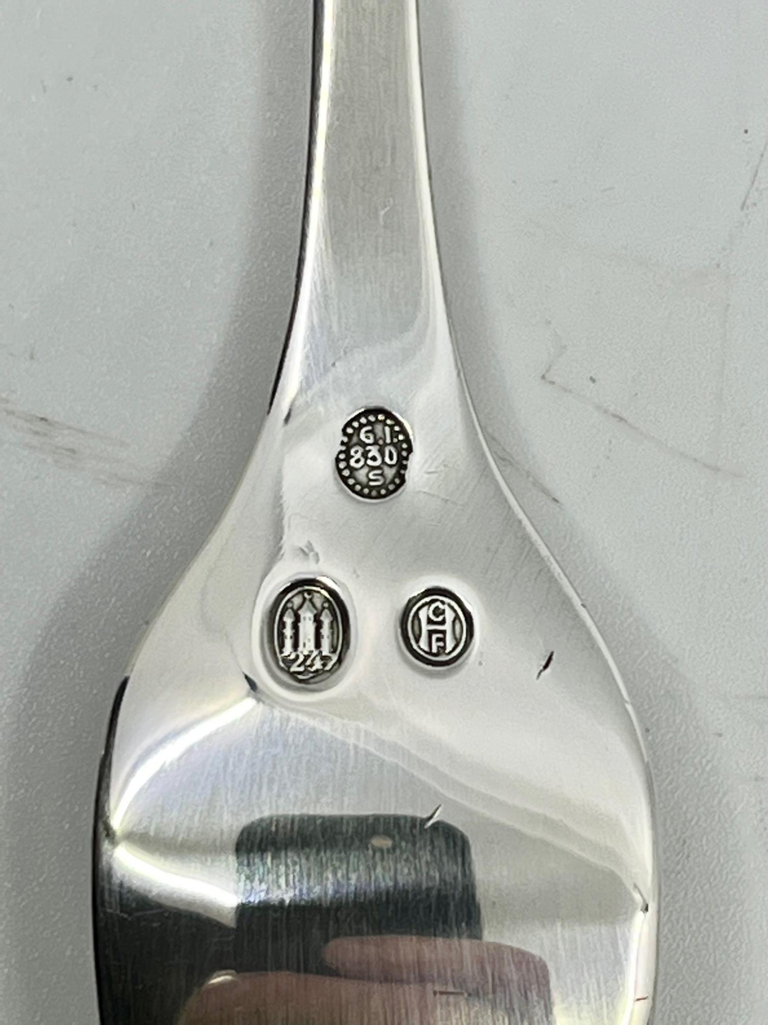 A rare Georg Jensen silver fish fork, item #061 in the Akkeleje pattern, design #77 by Georg Jensen from 1918. There is no English name for this pattern.

Additional information:
Material: Sterling silver
Styles: Art Nouveau
Hallmarks: With period