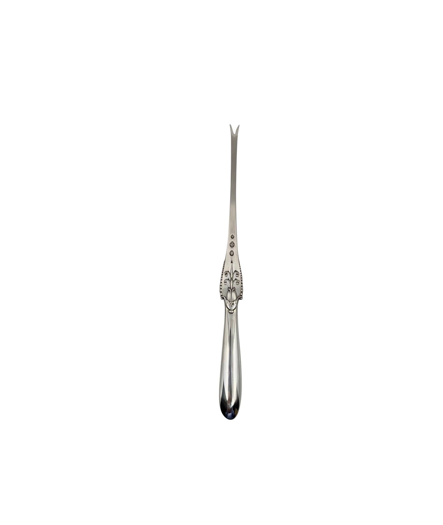A Georg Jensen silver lobster fork, item #065 in the Akkeleje pattern, design #77 by Georg Jensen from 1918.

Additional information:
Material: Sterling silver
Styles: Art Nouveau
Hallmarks: With period Georg Jensen hallmark, and Danish assay marks