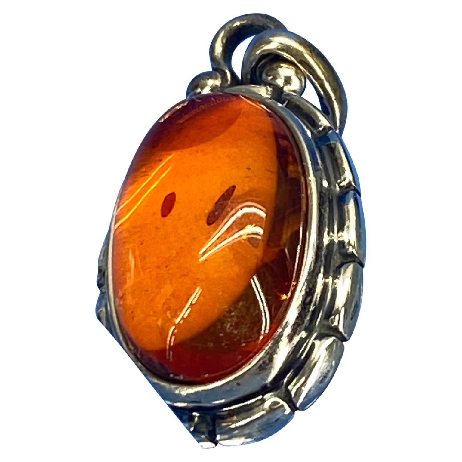 Georg Jensen annual pendant in sterling silver with amber stone, 2001. Pendant measures 2.4 cm and pendant measures 12 grams (0.40 oz).