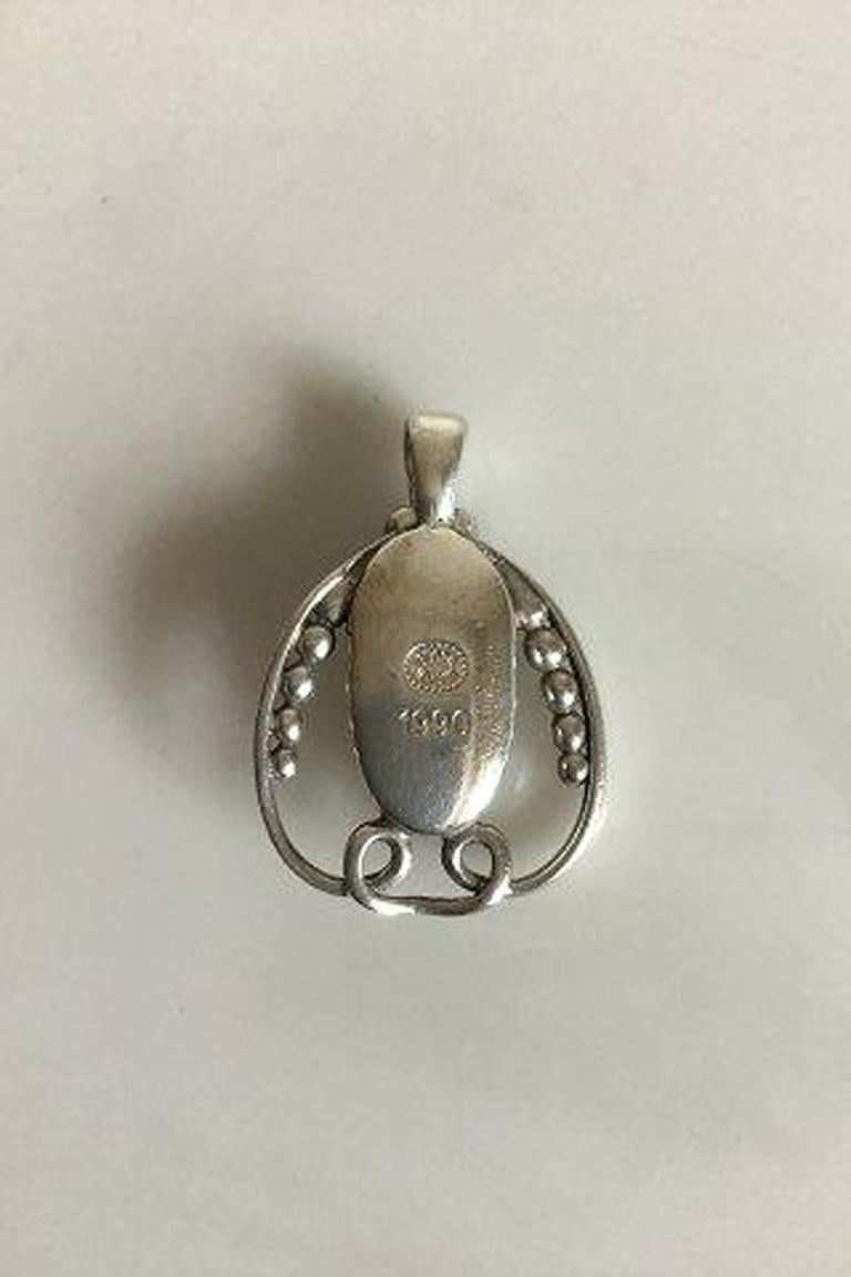 Georg Jensen annual pendent in sterling silver from 1990. 

Measures 2.8 cm / 1 7/64 in. Weighs 7.9 g / 0.28 oz.